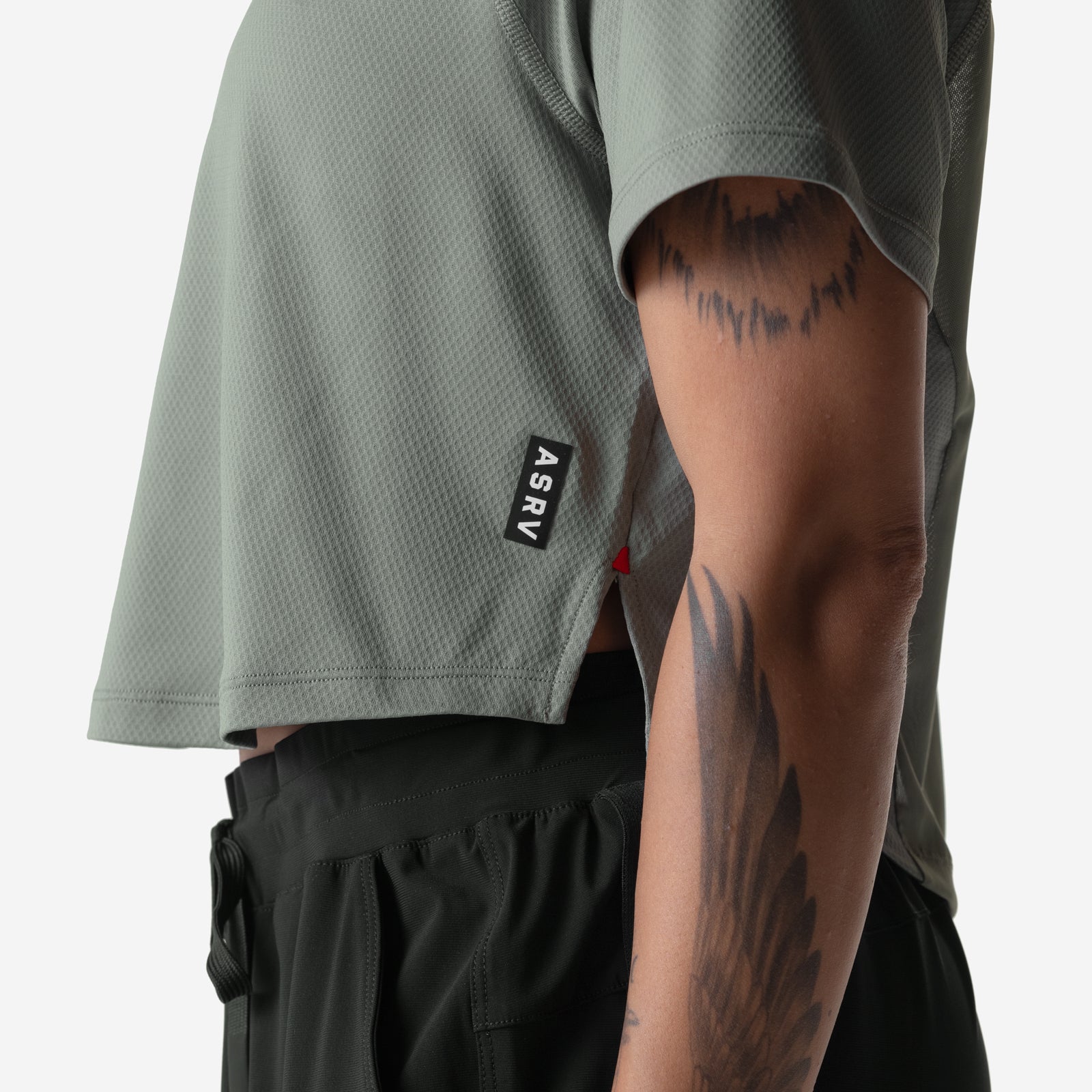 ASRV AeroSilver Cropped Training Tee in sage worn by model, side view