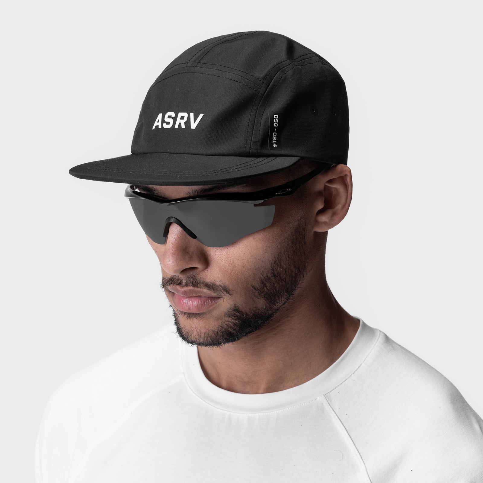 ASRV 0814 5-Panel Run Cap in black, worn by model with sunglasses