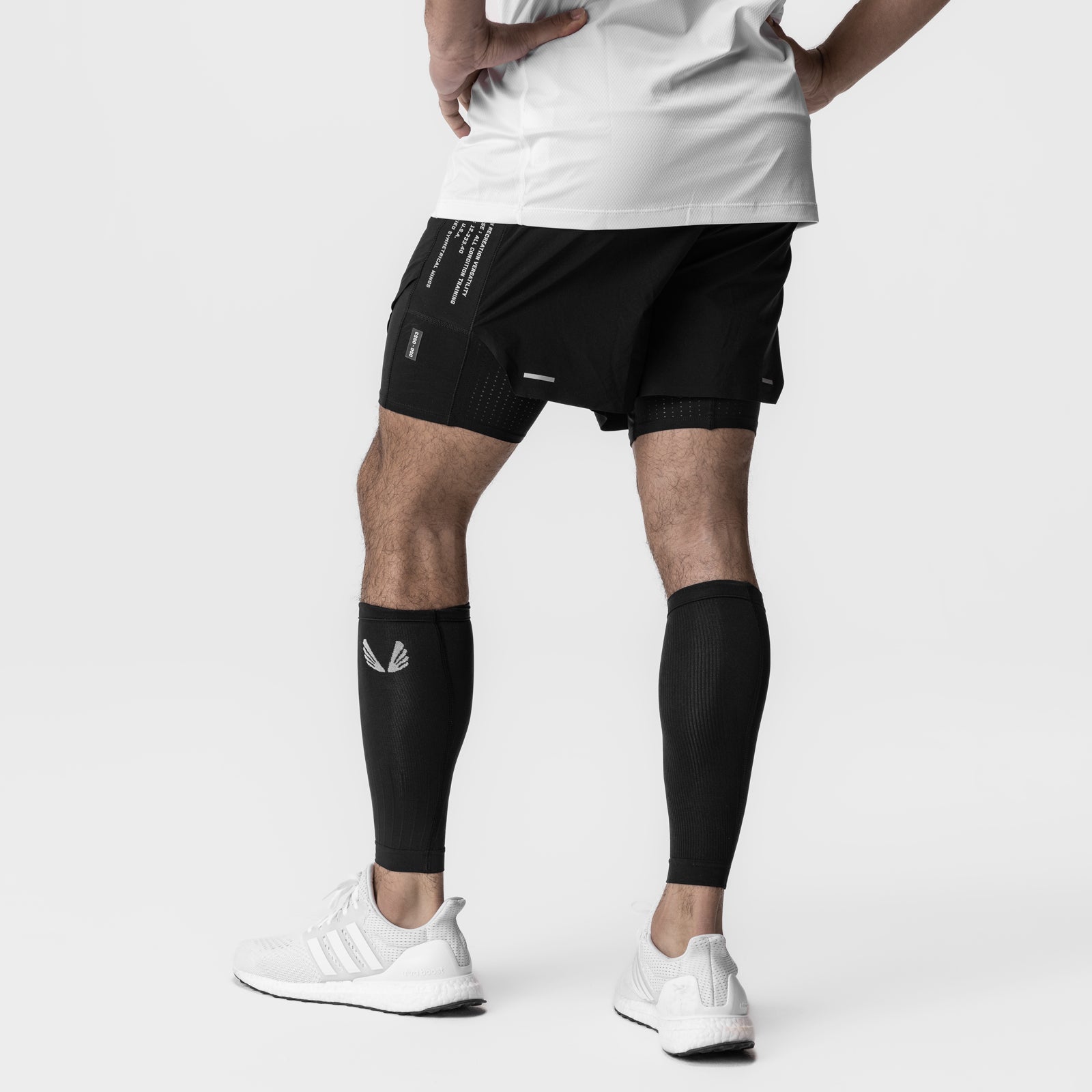 Body-Mapped Calf Sleeve in black, worn on model's leg during athletic pose