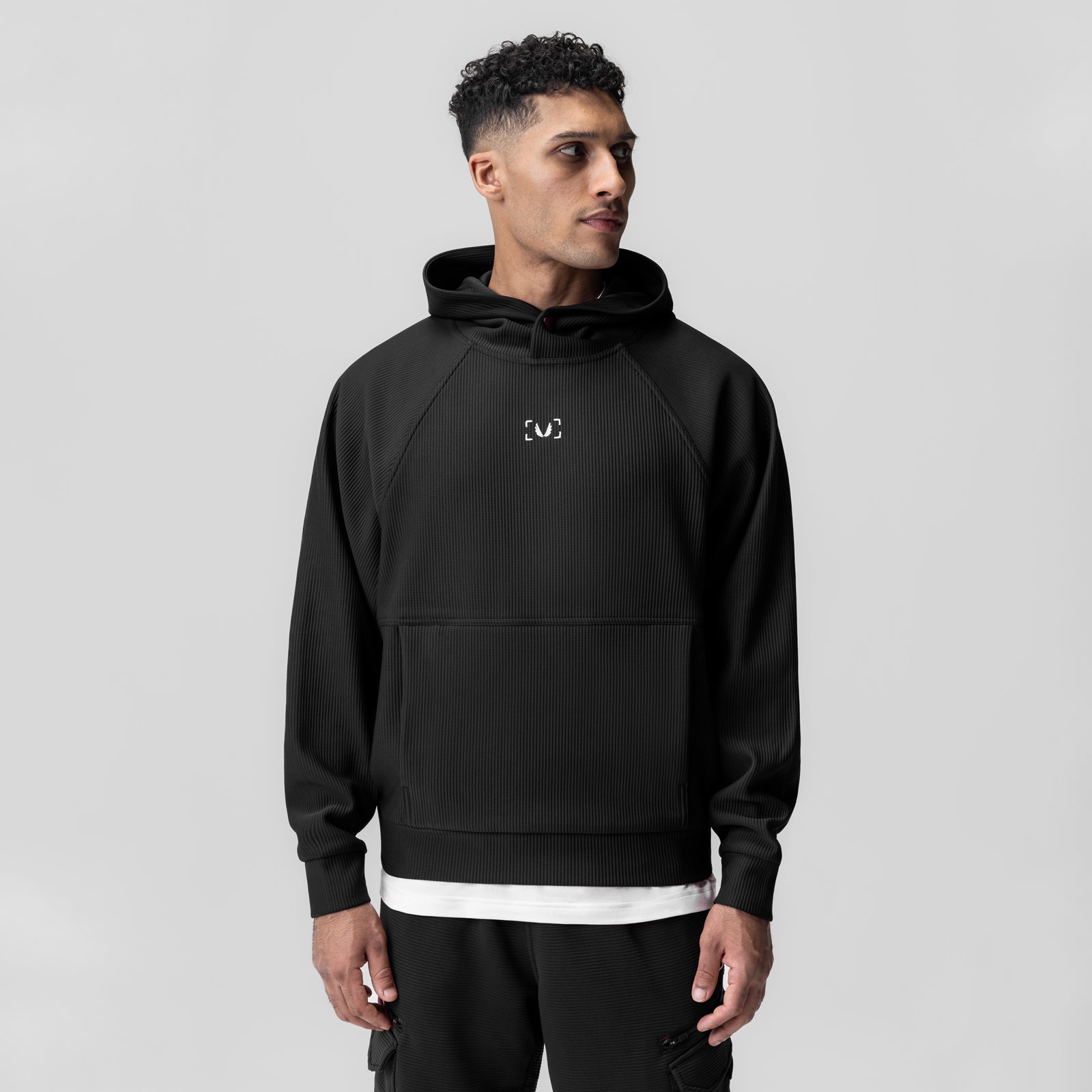 Deltapeak® Oversized Hoodie in black, worn by model facing forward, featuring small chest logo
