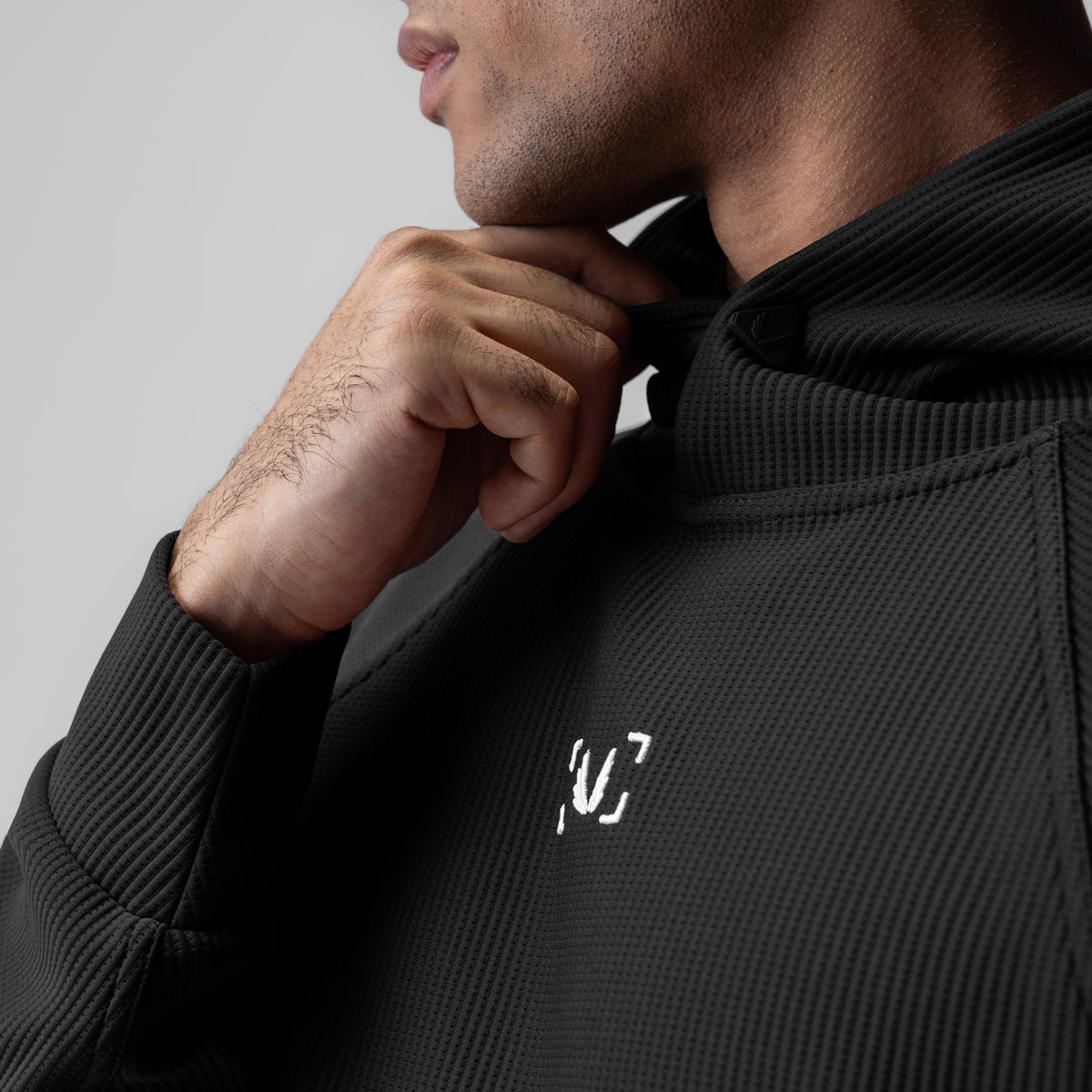 Deltapeak® Oversized Hoodie in black, worn by model adjusting hood
