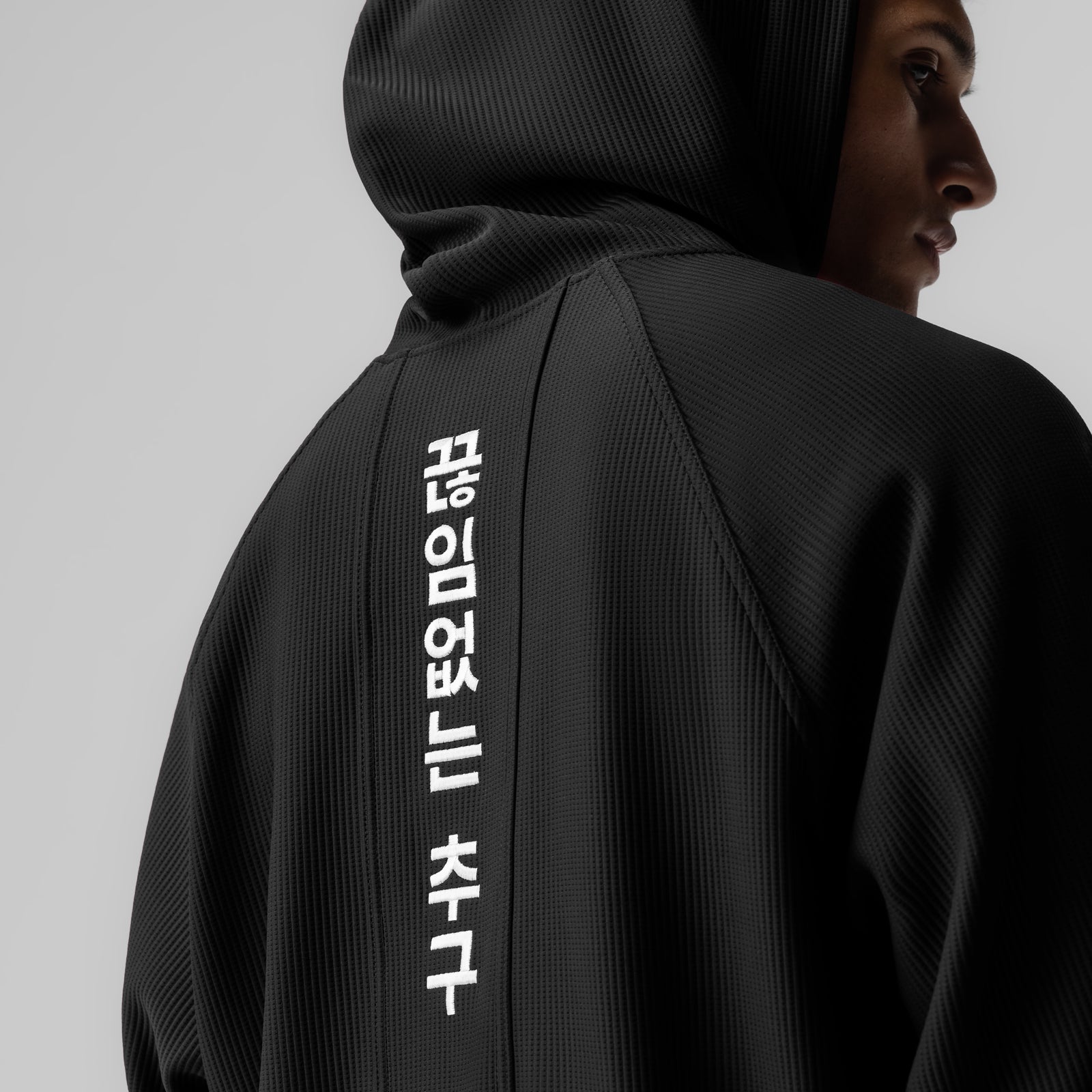 Deltapeak® Oversized Hoodie in black worn by model, back view with Korean text branding
