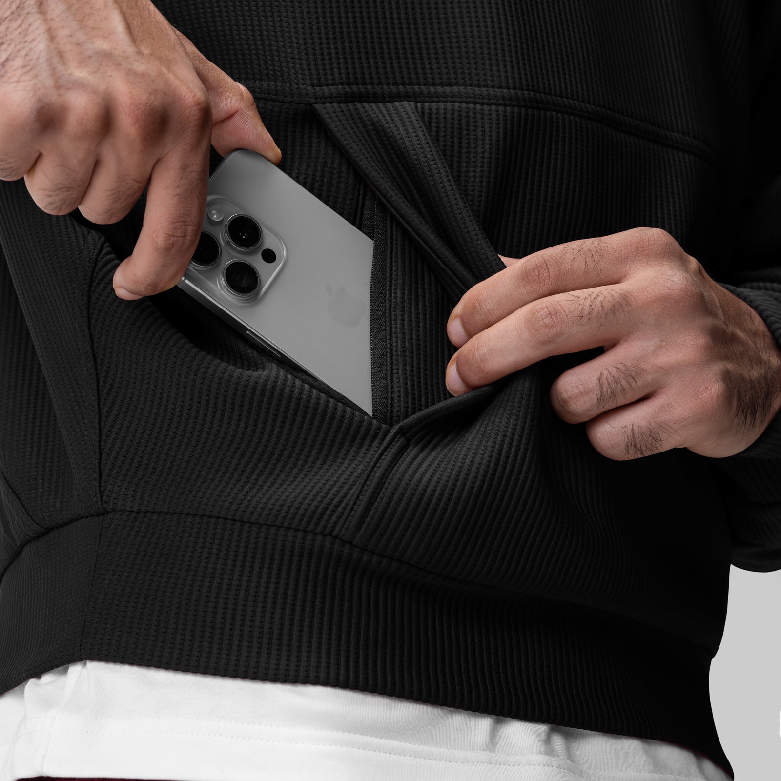 Deltapeak® Oversized Hoodie in black, worn by model holding smartphone in pocket