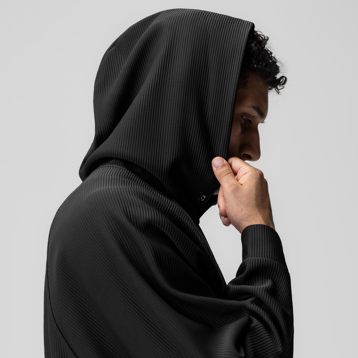 Deltapeak® Oversized Hoodie in black, worn by model in profile view with hood up