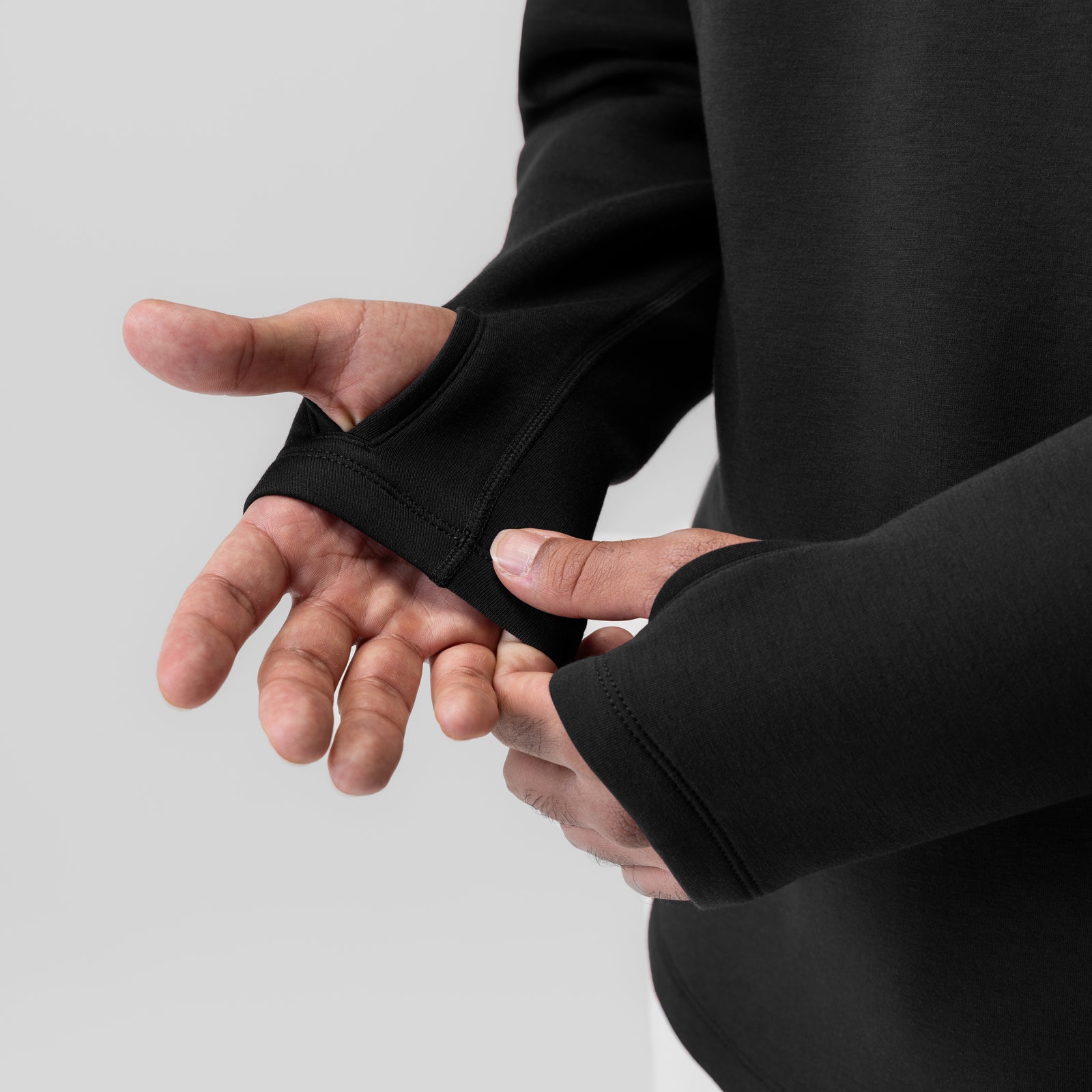 Dri-Core™ Zip Hoodie in black, worn with model showing thumb loop cuff detail