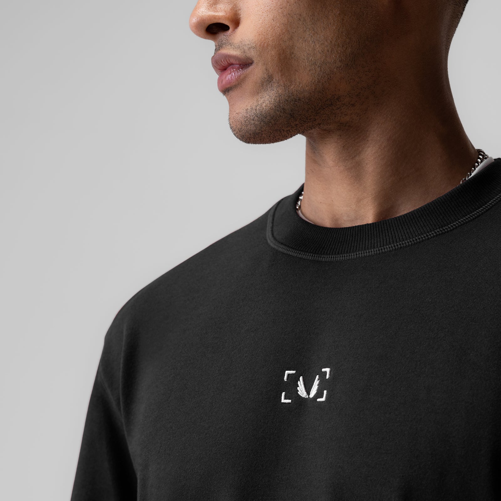 Herringbone Terry Oversized Cinch Tee in black, modeled from side profile view