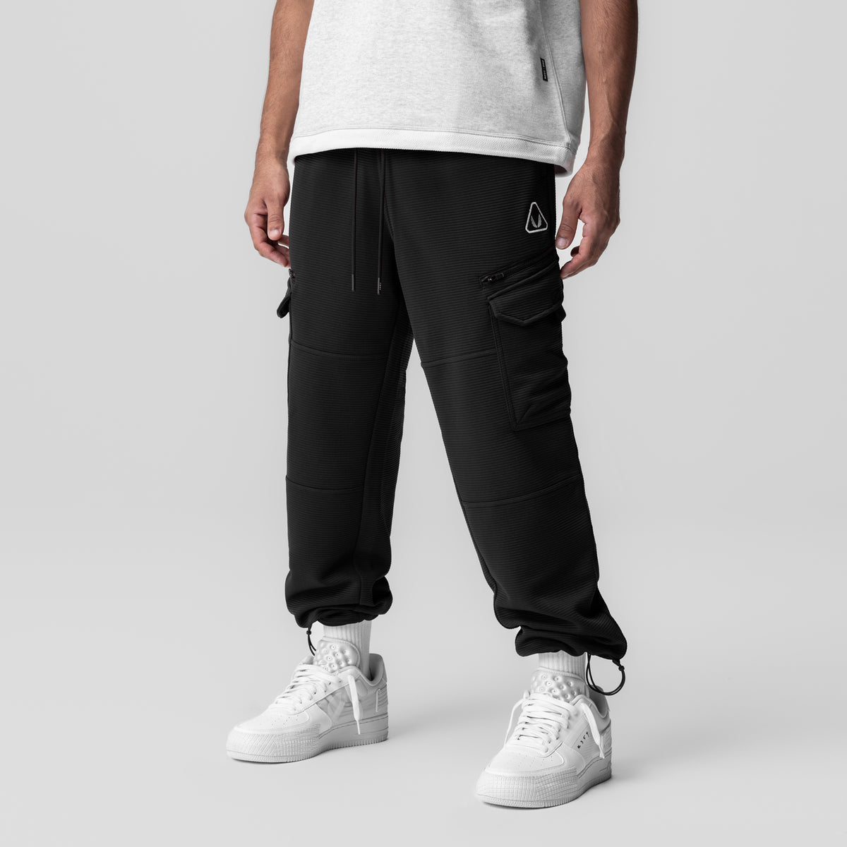 Deltapeak® Cargo Cinch Jogger in black worn by model with white sneakers, front view