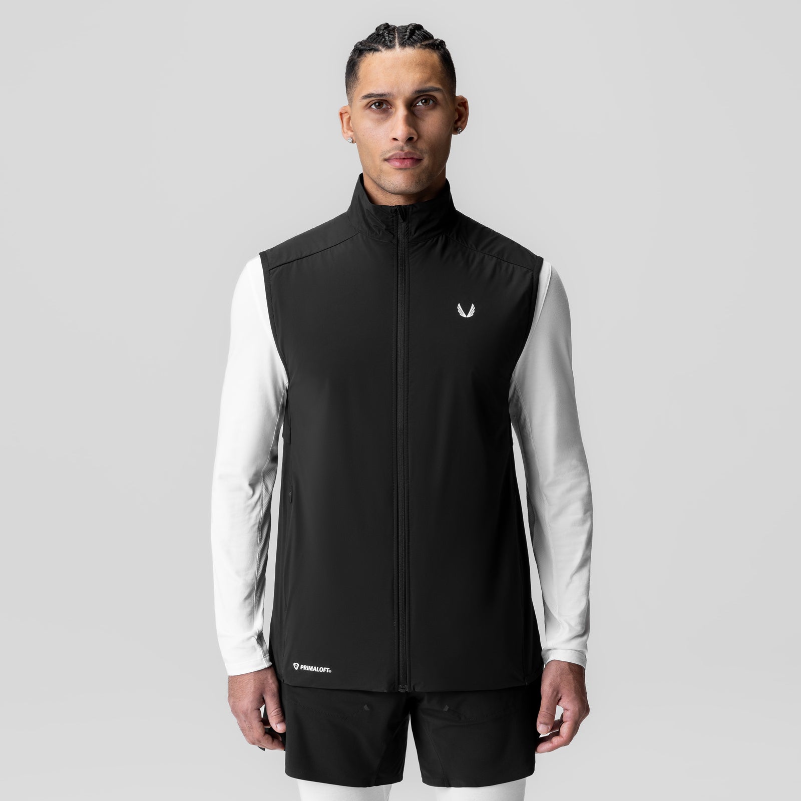 Aerotex PrimaLoft Run Vest in black, worn by male model with white long-sleeve shirt