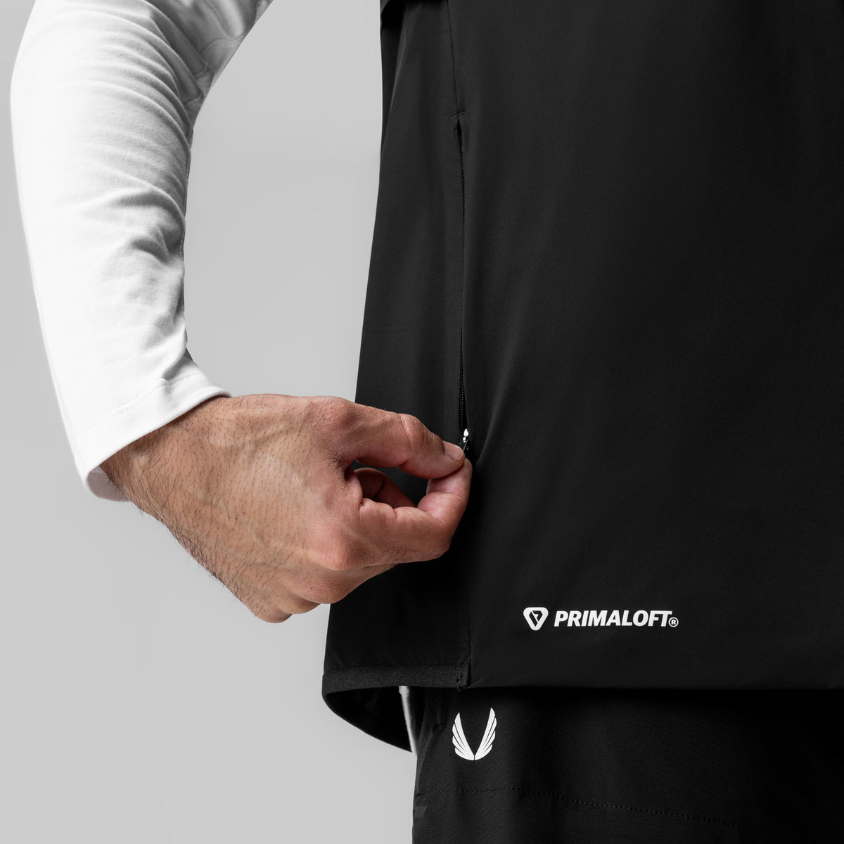 Aerotex PrimaLoft Run Vest in black, worn by model with white long-sleeve shirt