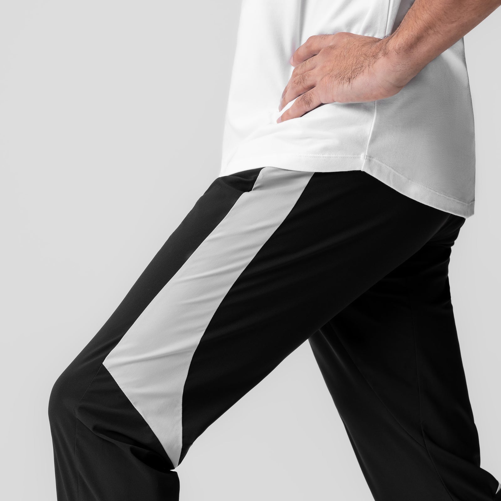 Black and white Tetra-Lite cuffed training jogger worn by model, side view