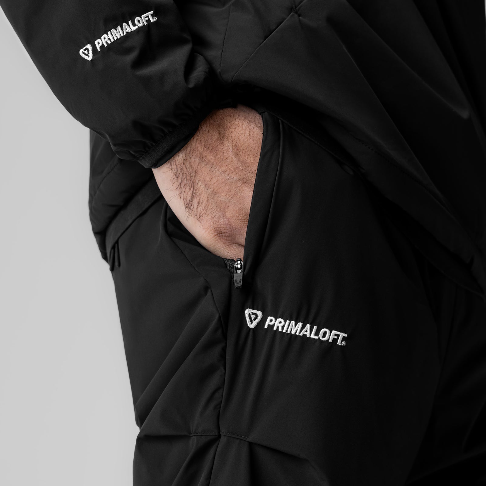 Aerotex PrimaLoft Warm-Up Pant in black, worn with hand in pocket detail