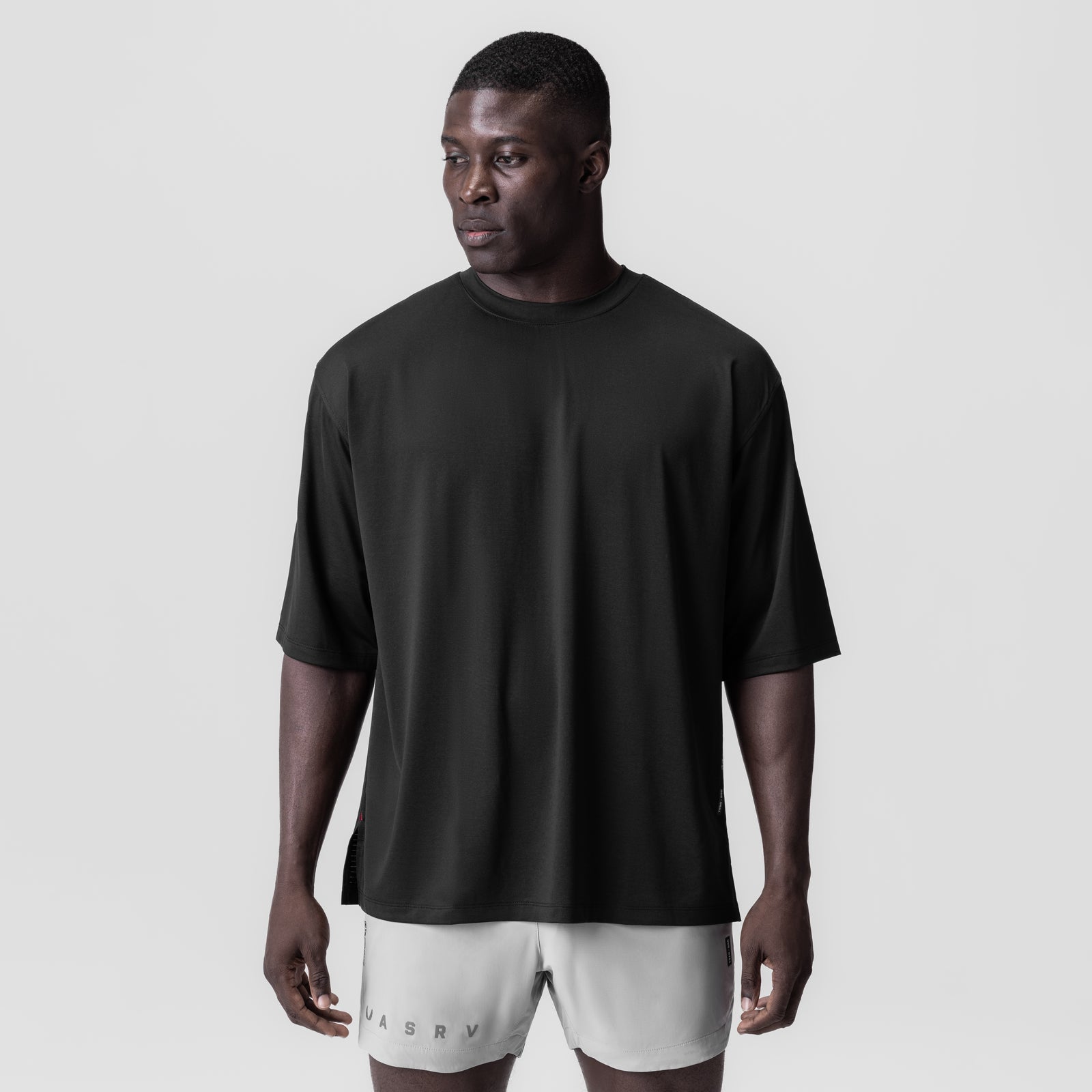 Black oversized tee with white shorts on model, front view