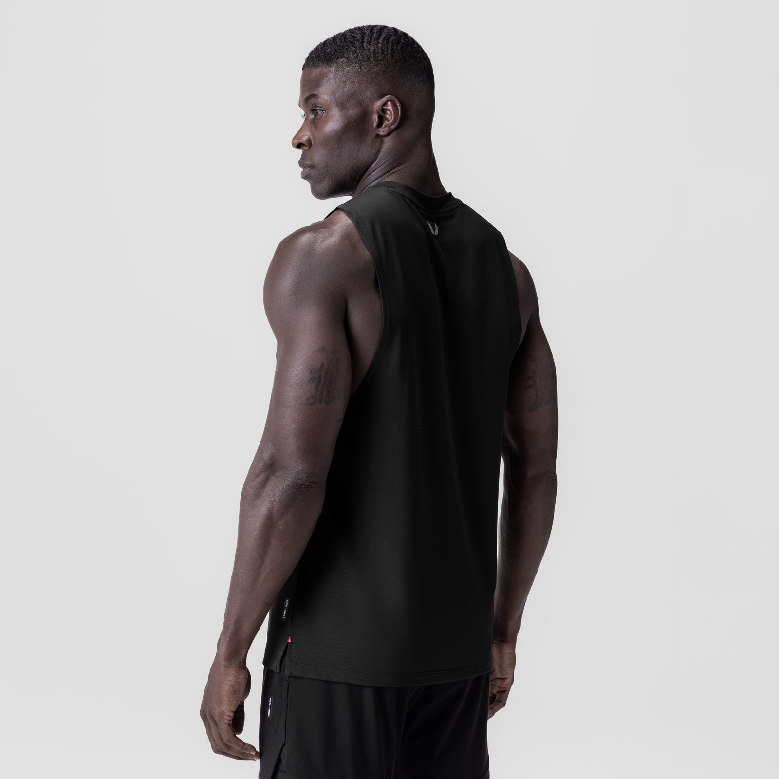 Black 3D-Lite® 2.0 Lycra® muscle tank worn by model, side profile view