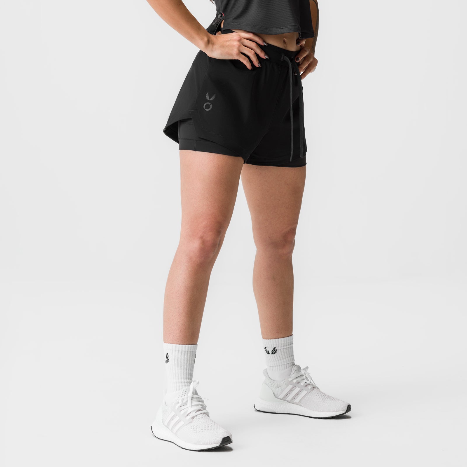 Black Tetra-Lite 4" Liner Short worn by model, front view with white socks and sneakers