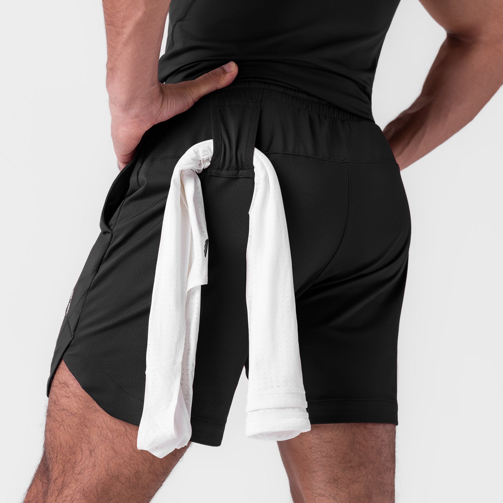 AeroSilver 7" Linerless Short in black, worn by model with towel, back view