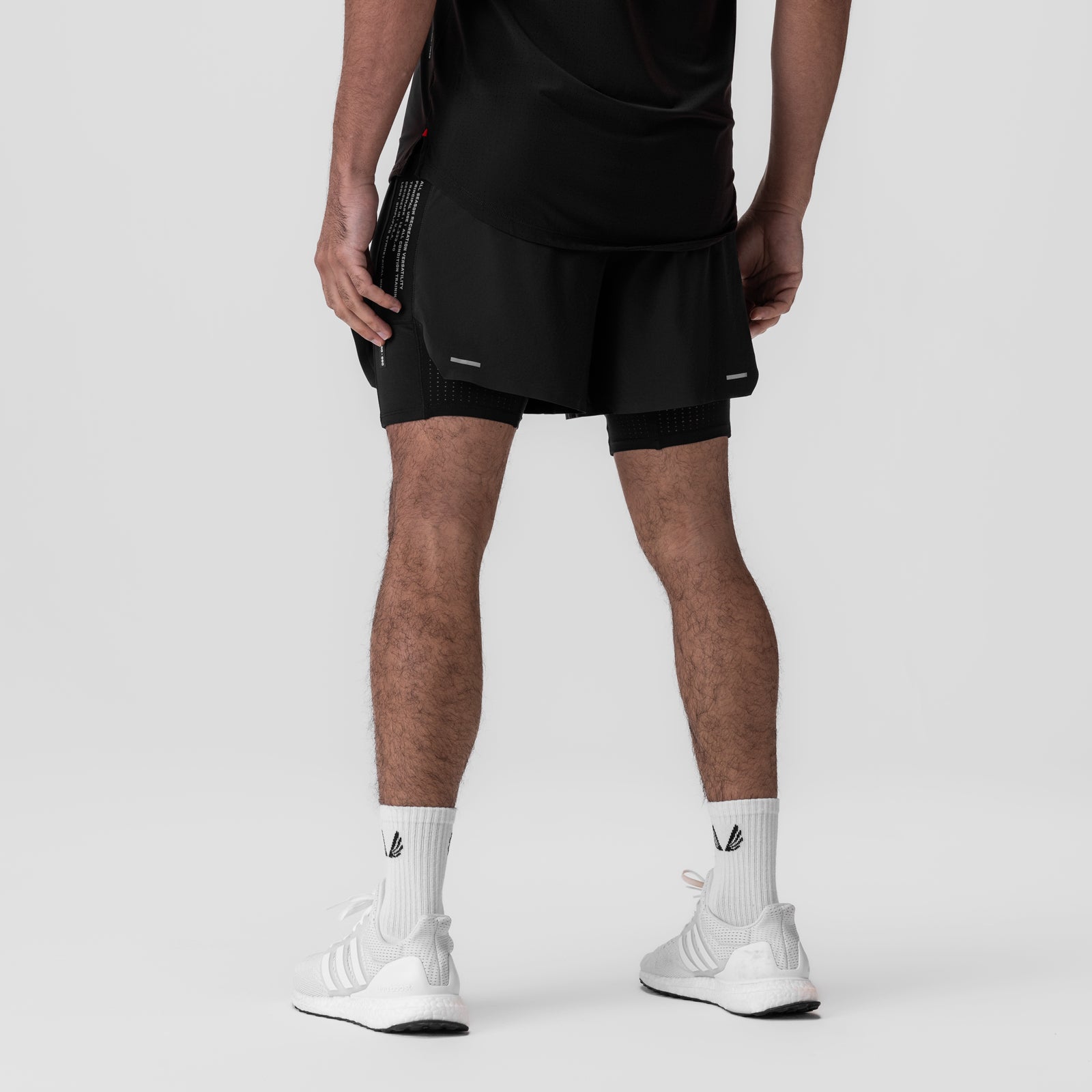 Aerotex Hybrid Liner Short in black, worn by model with white socks, back view