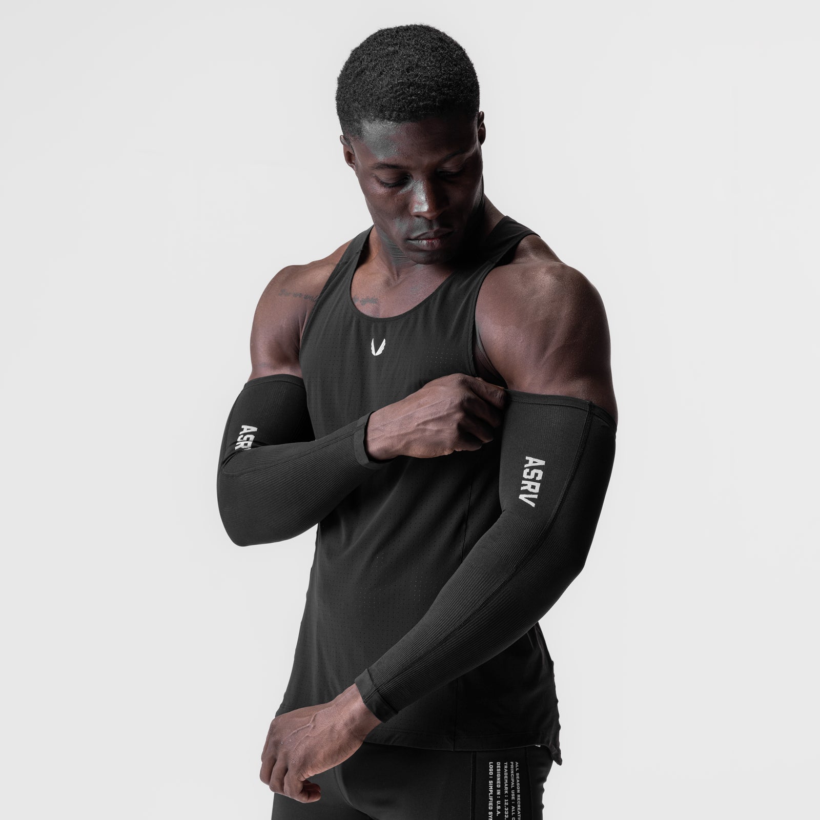 Black body-mapped arm sleeve worn on model, front view