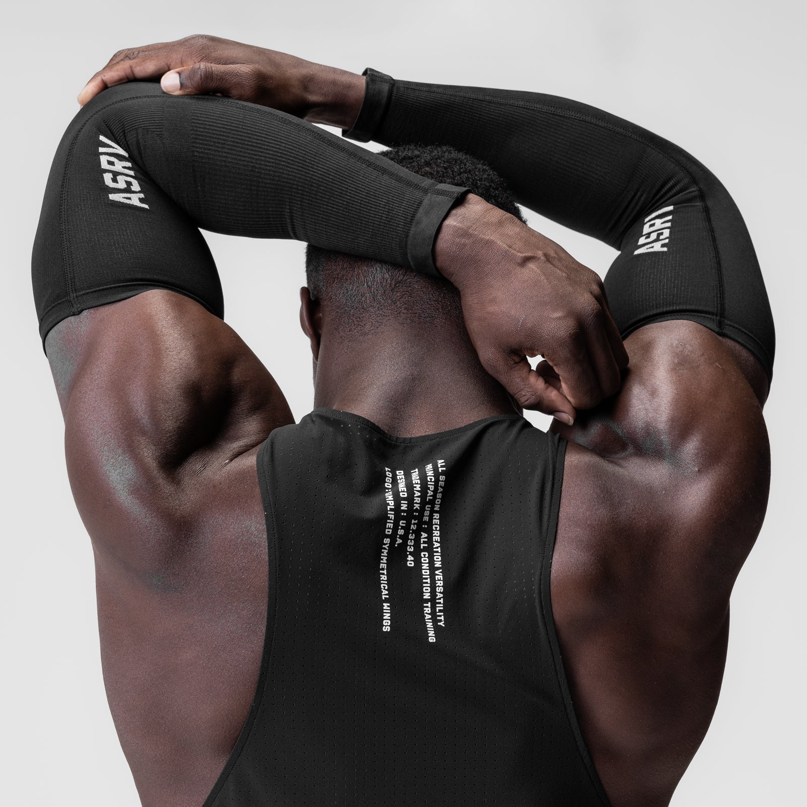 Body-Mapped Arm Sleeve in black worn by model, overhead pose showcasing fit