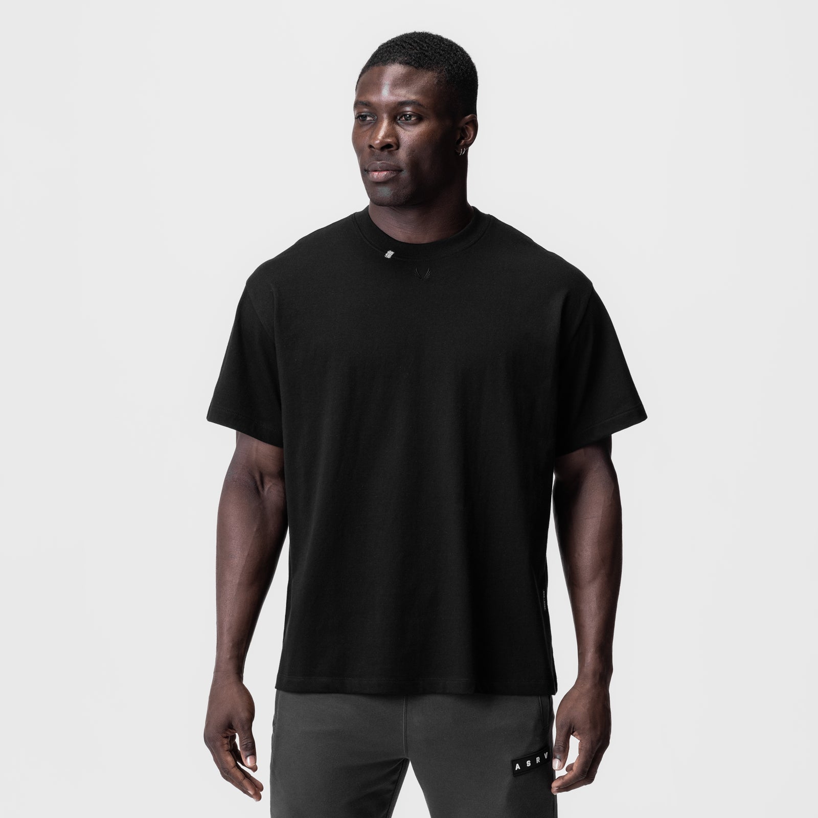 Tech Essential Relaxed Tee in black, worn by model, front view