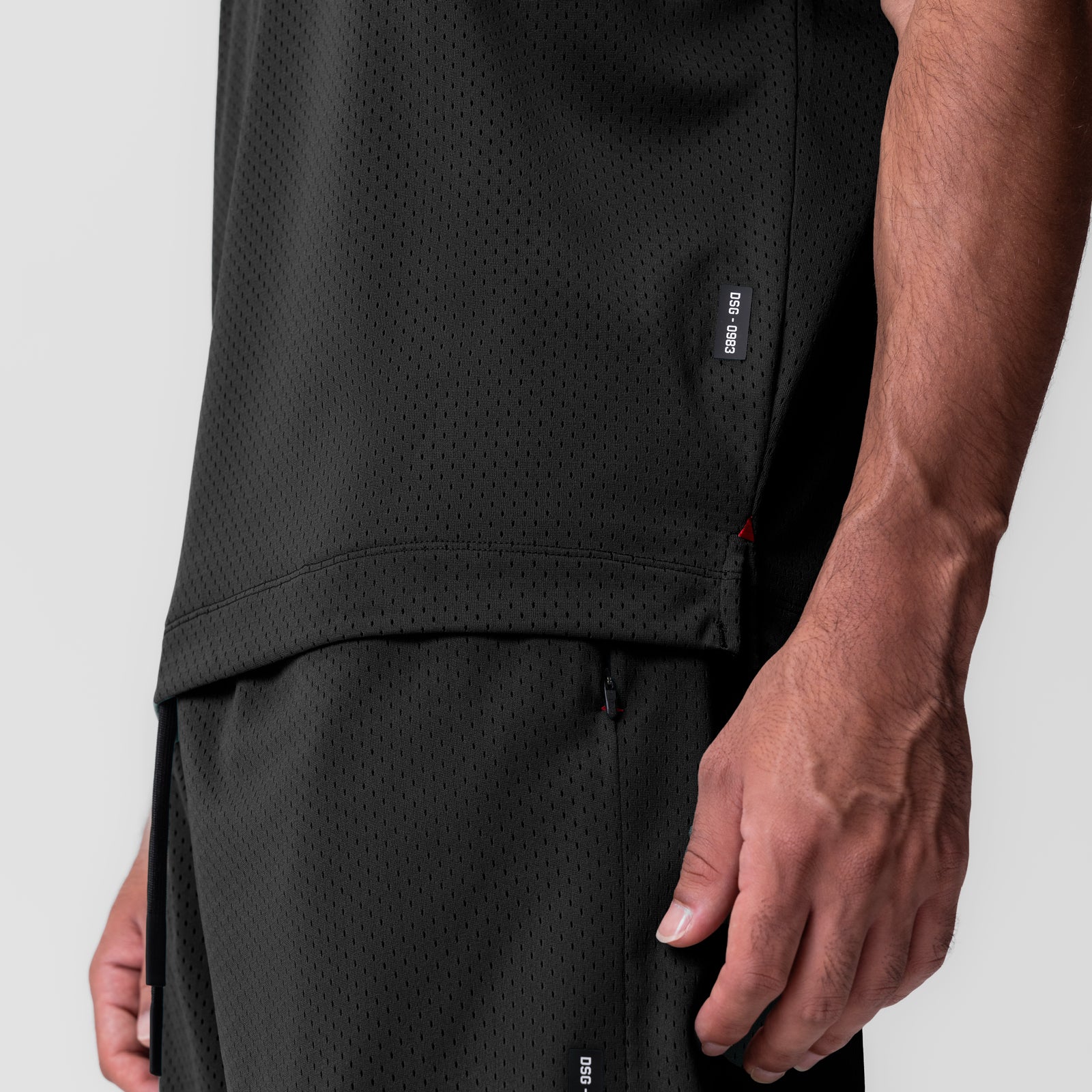 Black reversible 2-in-1 cutoff hoodie worn by model, side detail view