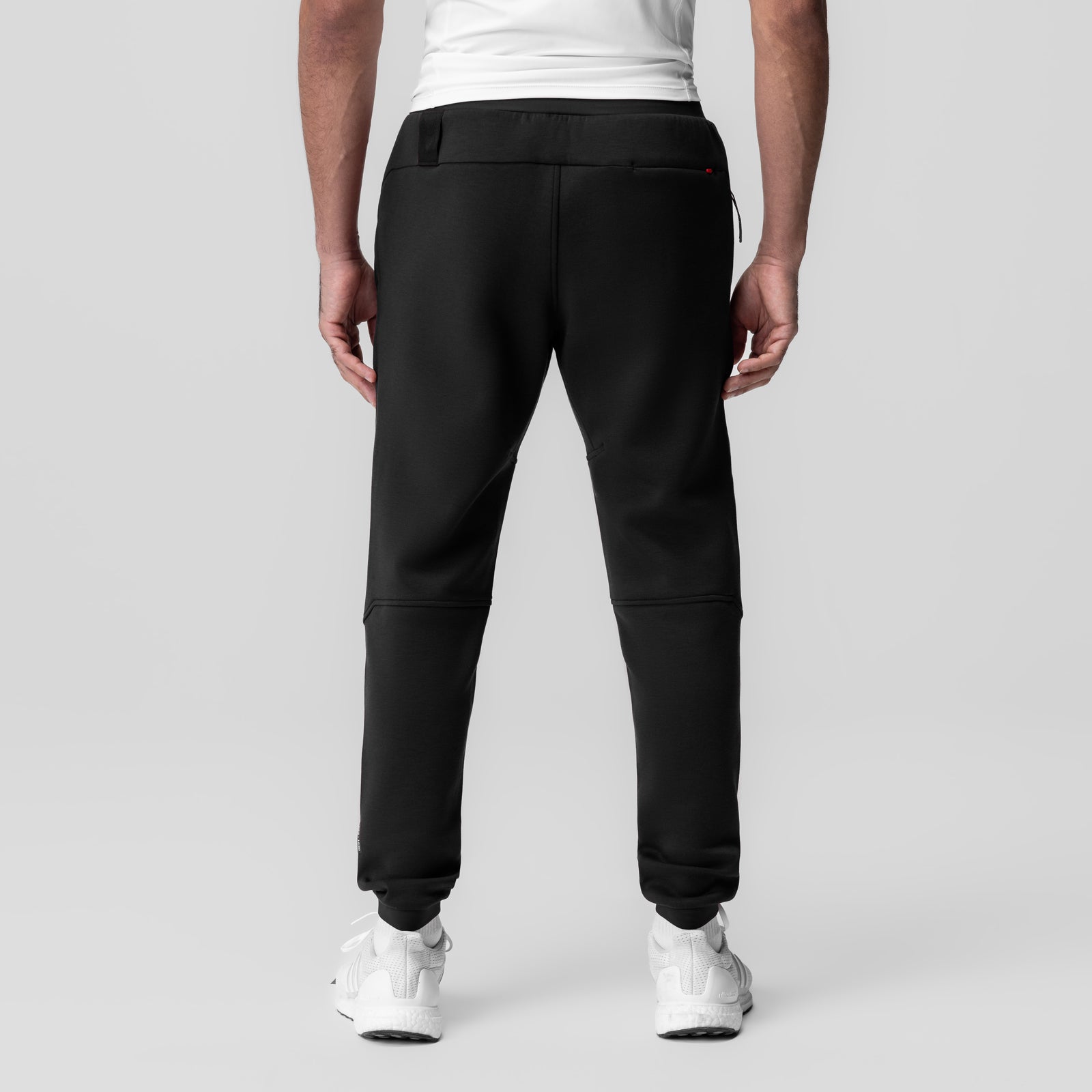 Dri-Core Training Jogger in black, back view on model wearing white sneakers