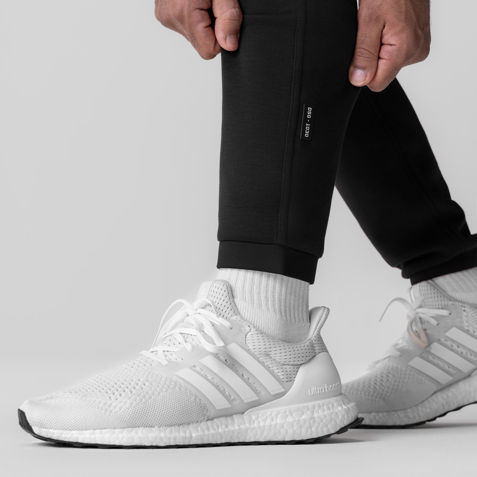Black Dri-Core Training Jogger worn with white socks and sneakers, side view