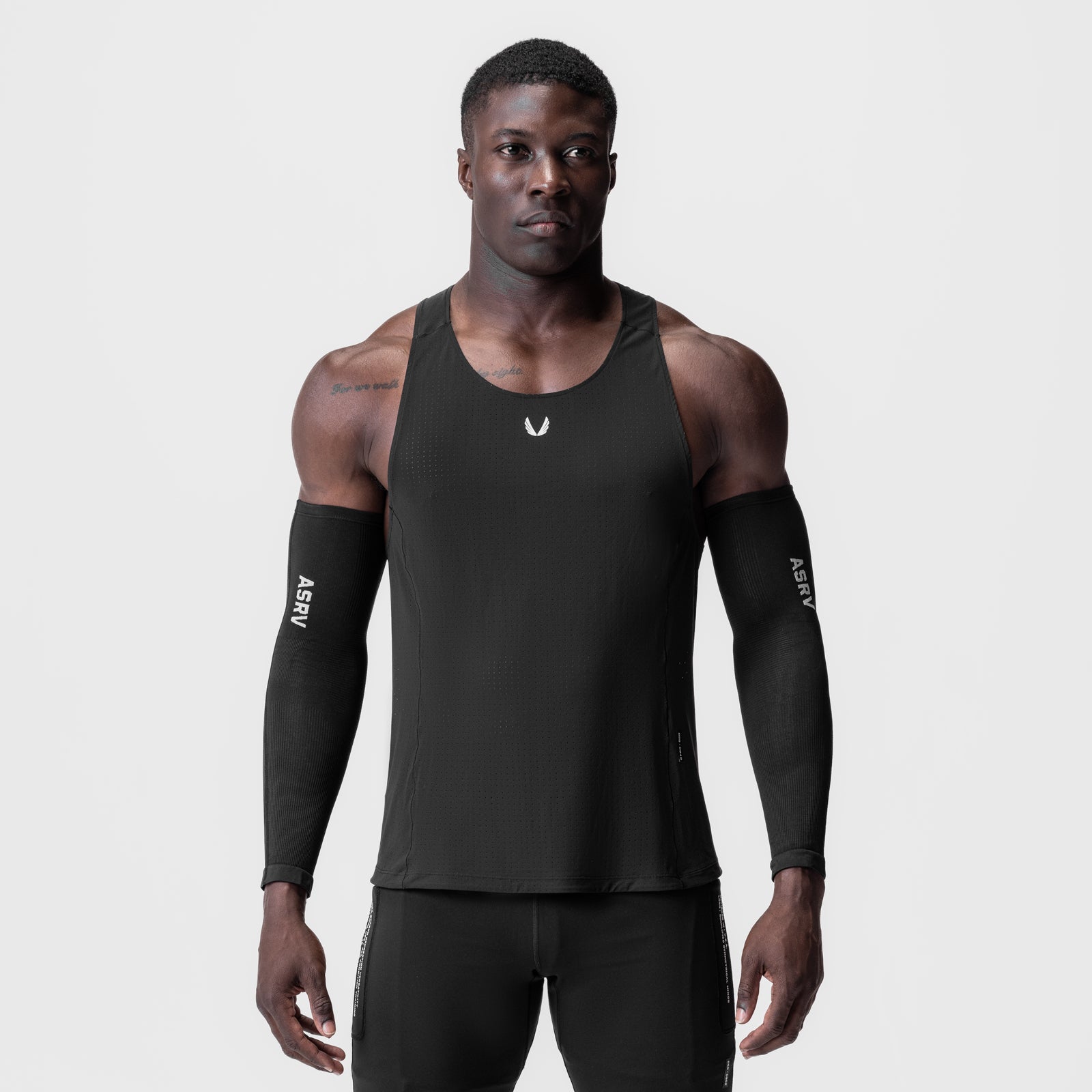 Laser-Vent™ Singlet Tank in black worn by male model with black arm sleeves, front view