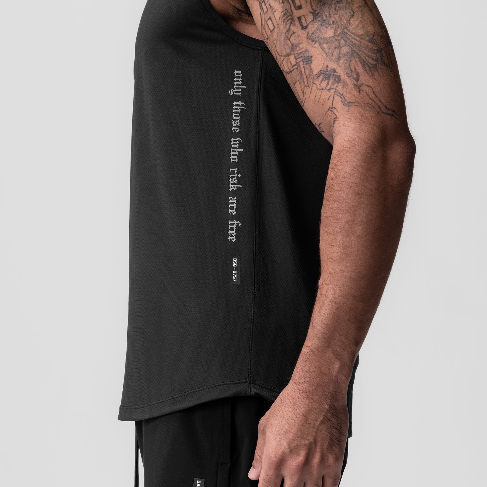 AeroSilver Cutoff Tank in black worn by model, side view showing text graphic