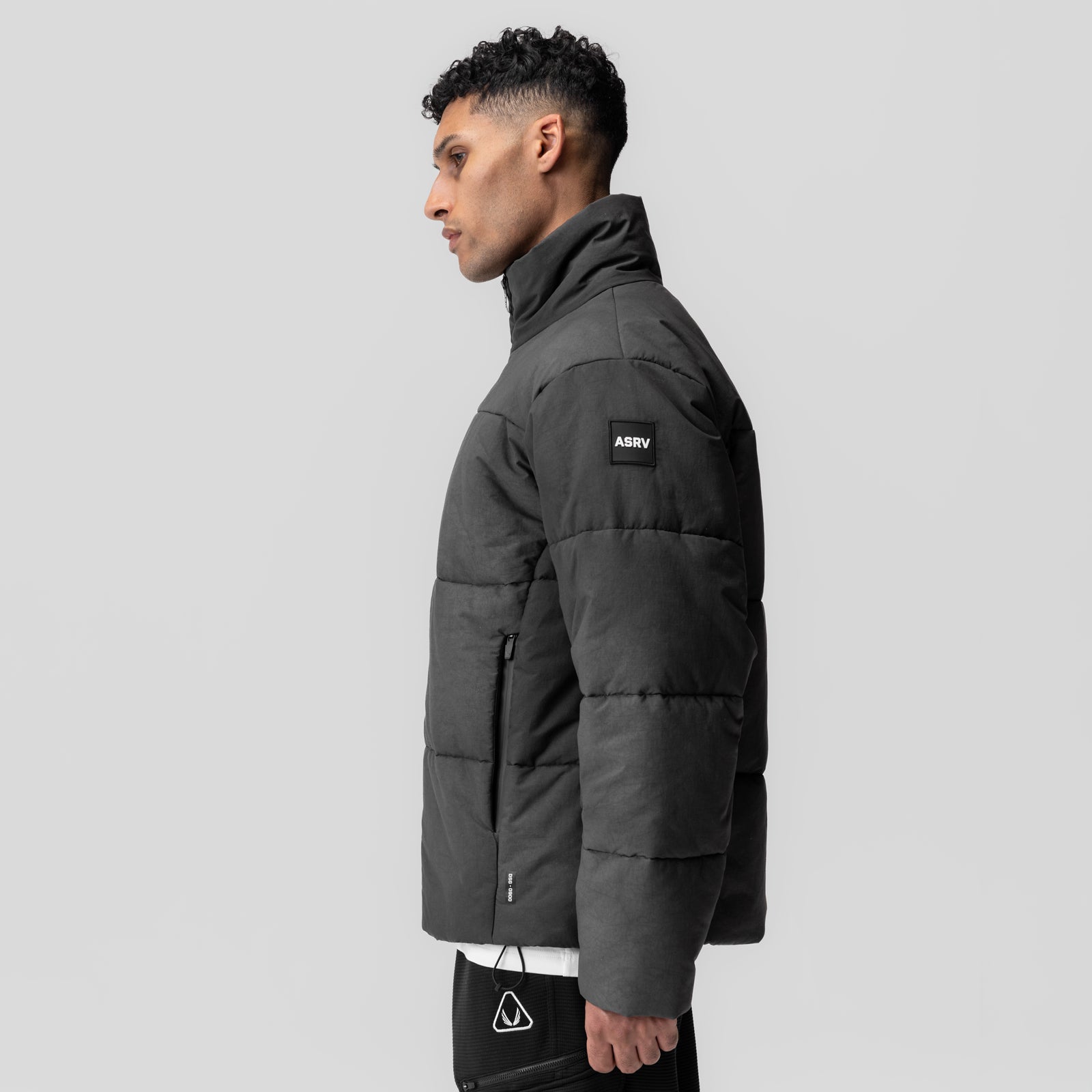 Black PrimaLoft Weather-Ready Puffer Jacket worn by model in side profile view