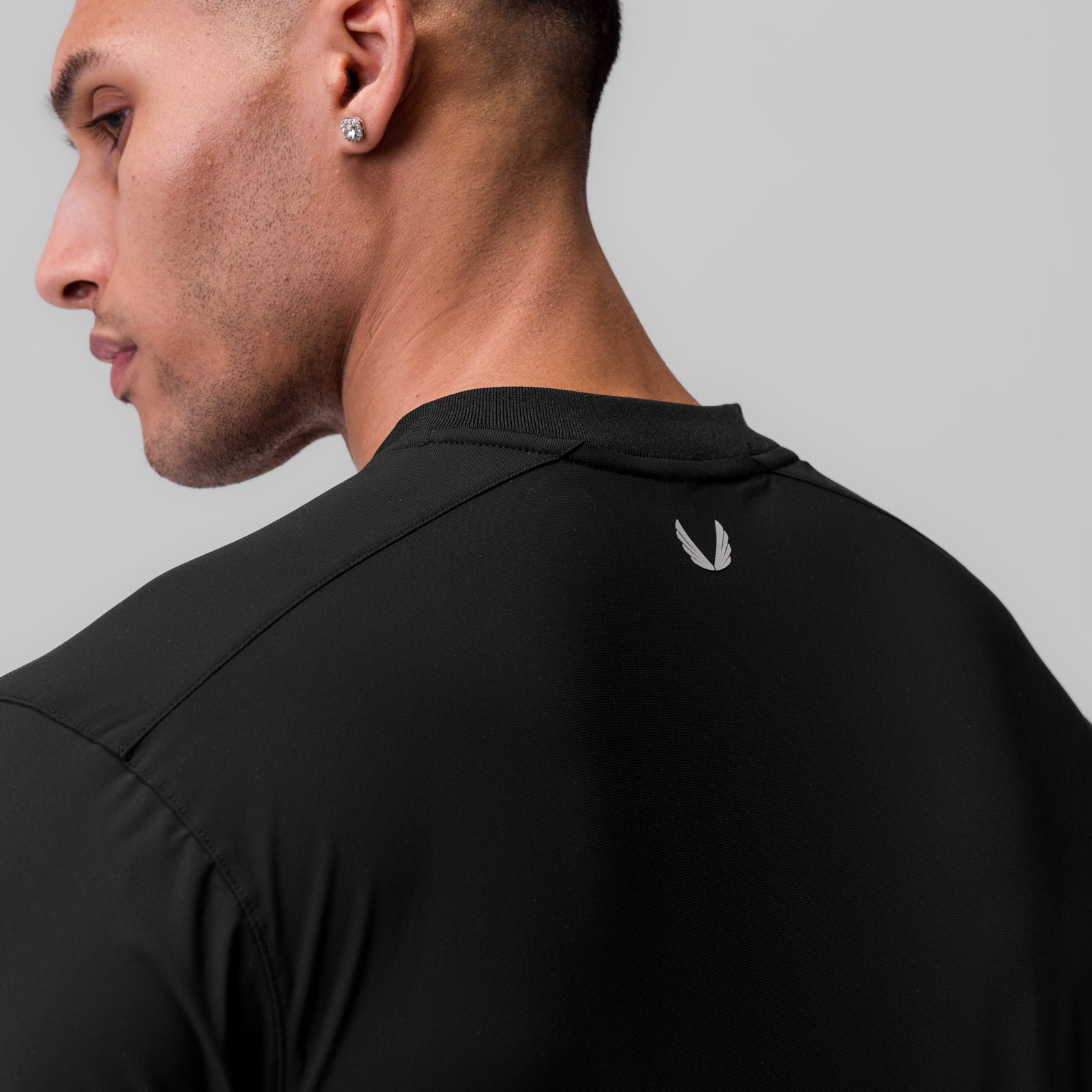 Tetra-Lite® Ice Zip Tee in black, worn by model in profile view