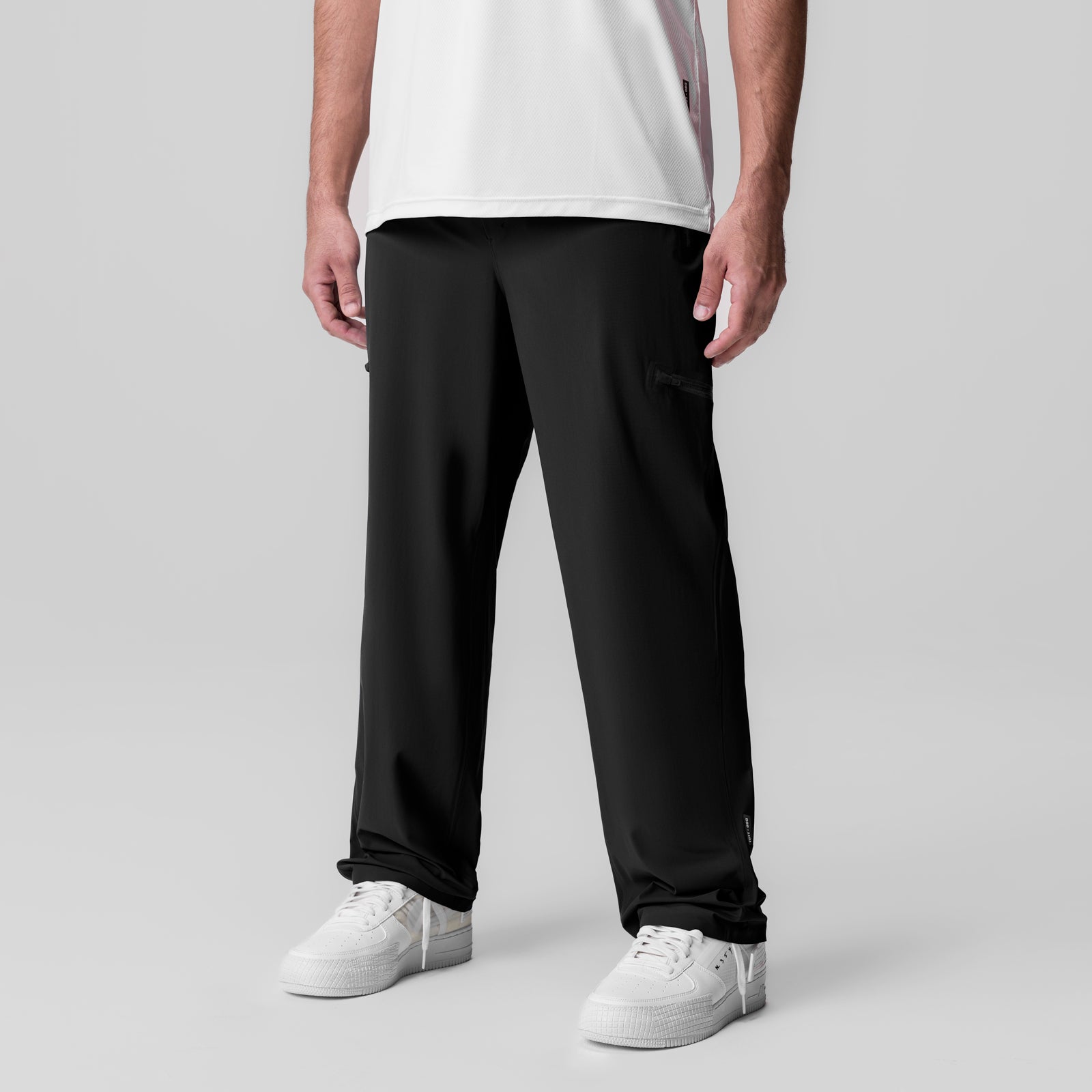 Tetra-Lite Field Pant in black, worn with white sneakers, front view on model