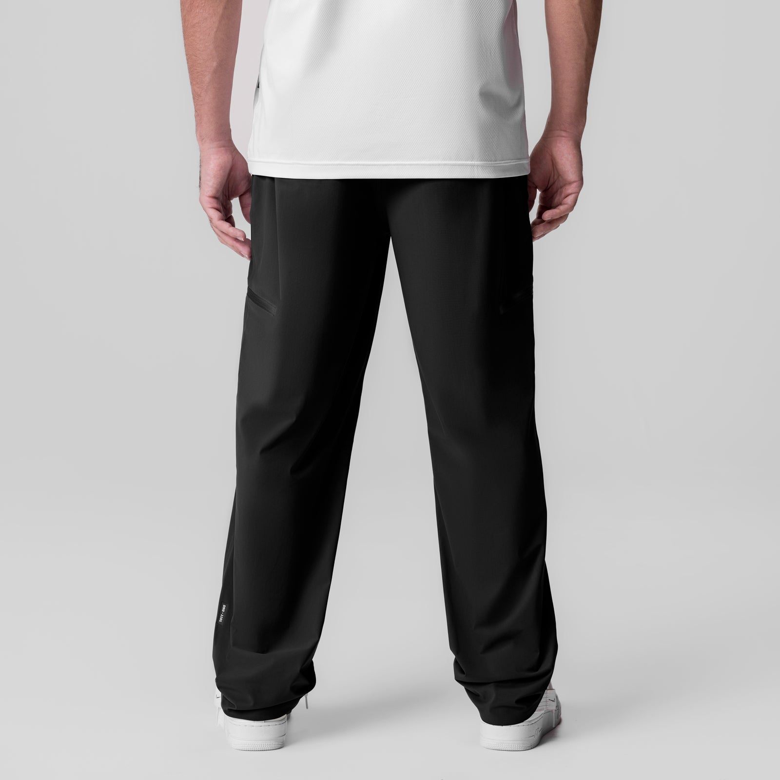 Tetra-Lite Field Pant in black, back view on model wearing white tee