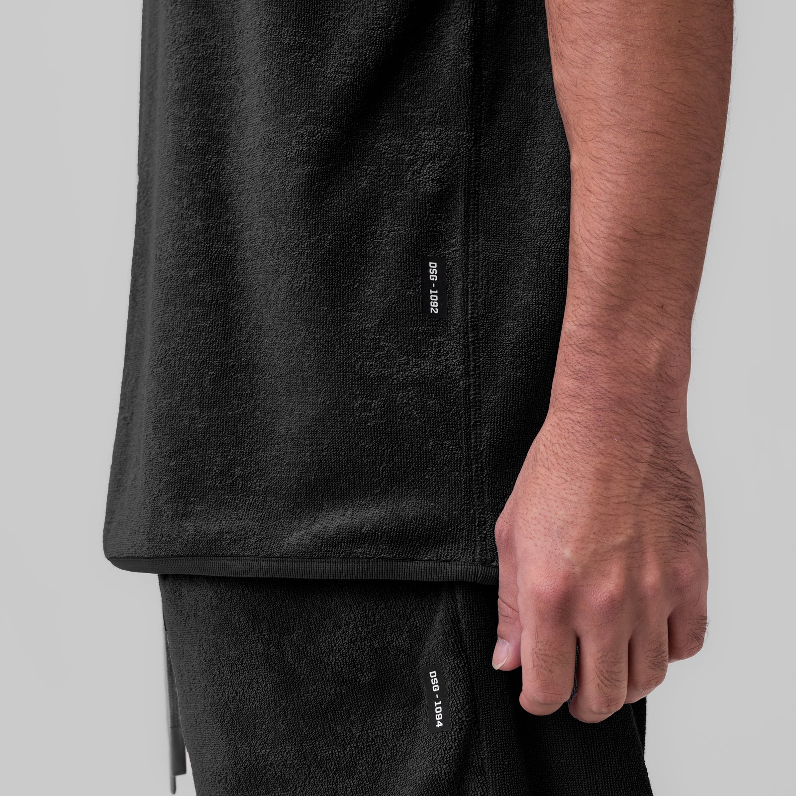 Towel Terry Cutoff in black worn by model, side detail view showing fabric texture