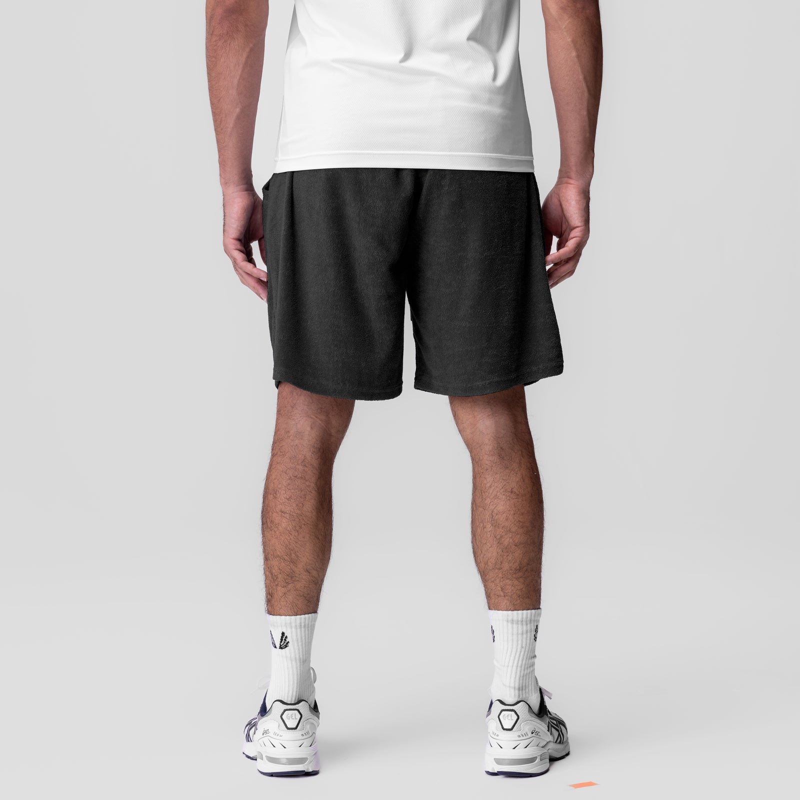 Towel Terry Relaxed Short in black, worn by model with white tee and white sneakers, back view