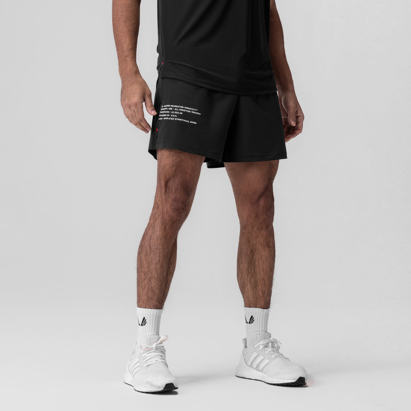 Black Aerotex Training Short 5" worn by model with white socks and sneakers, front view