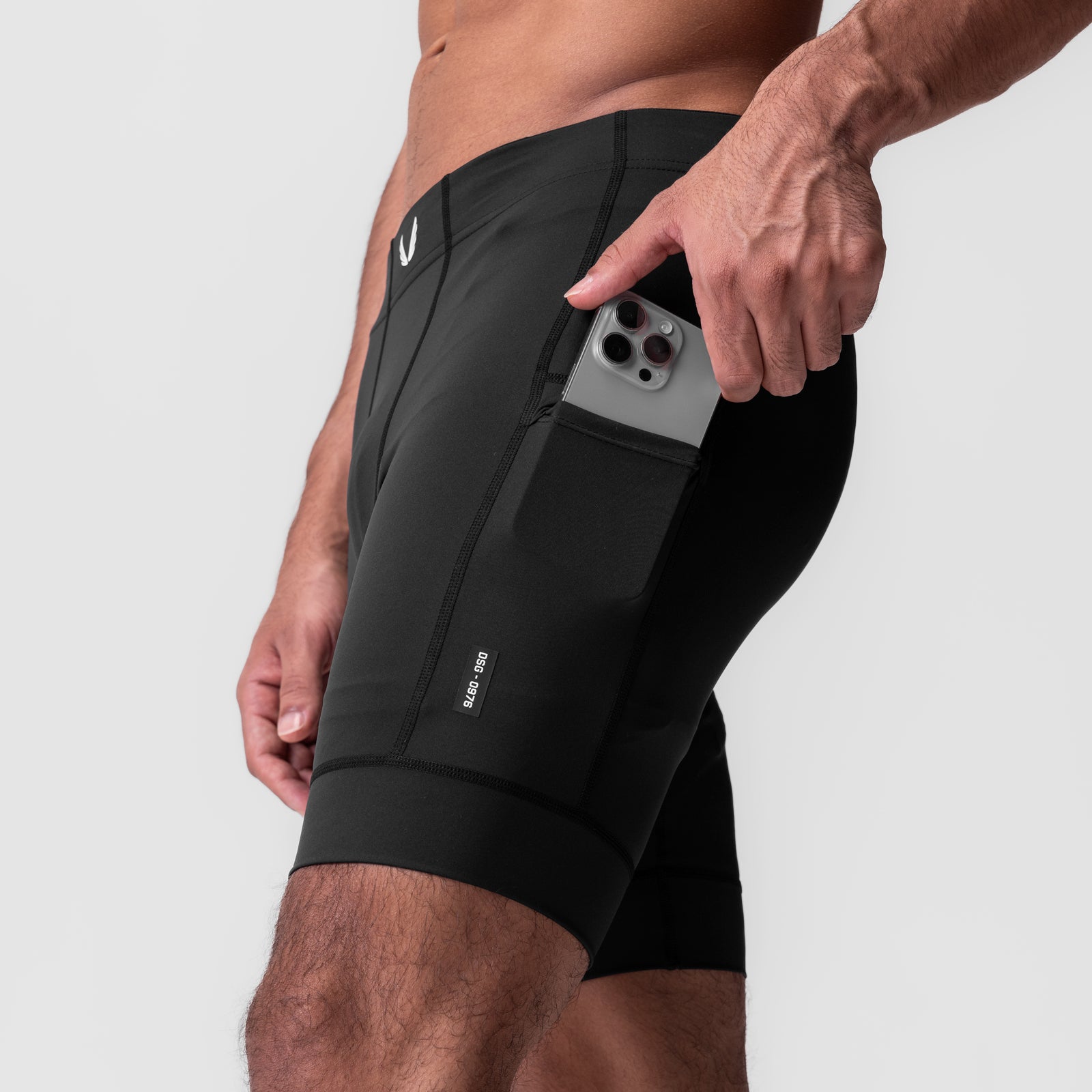 WarpFlexx-Lite 1/2-length legging in black, worn by model holding phone in side pocket