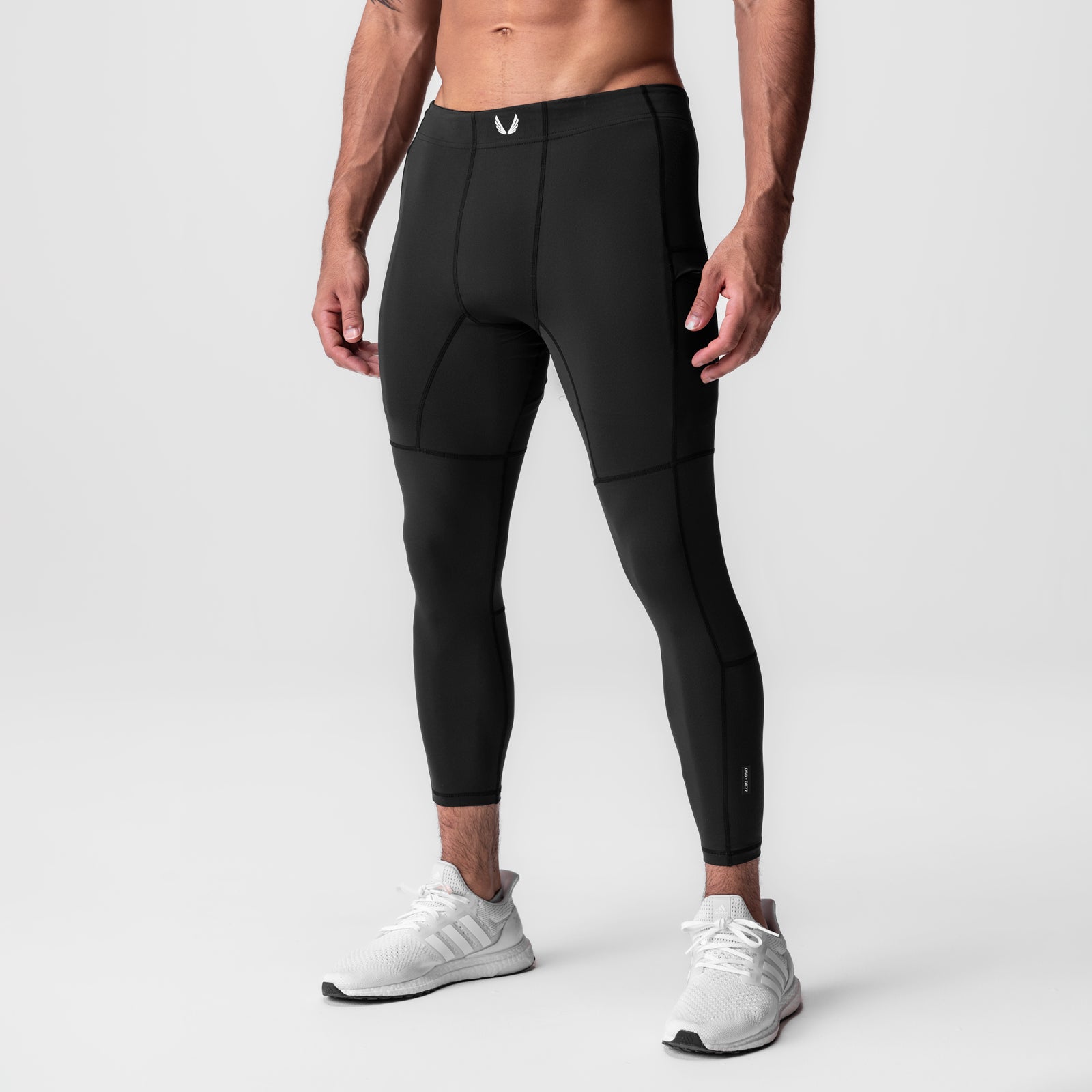 WarpFlexx-Lite® 3/4-Length Legging in black, modeled on male athlete wearing white sneakers