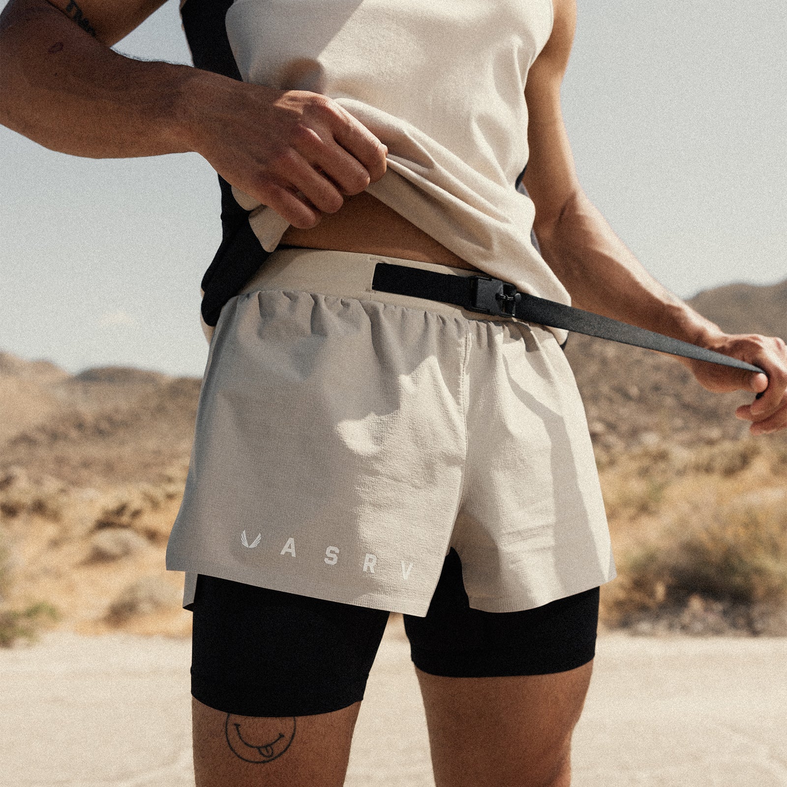Ripstop 3" Belt Pack Short in beige and black worn by model in desert setting