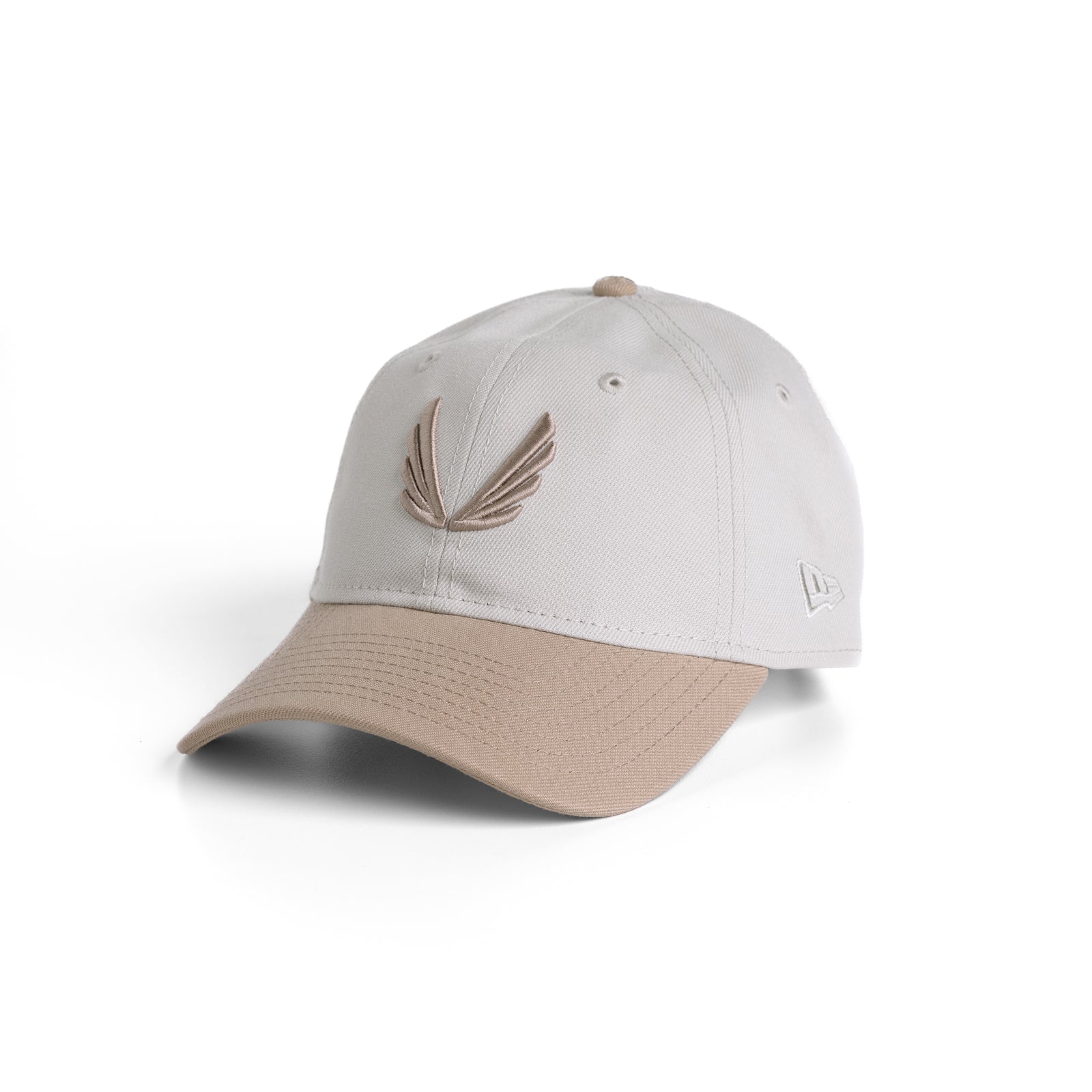 flatlay New Era 9Twenty Strapback Hat in stone and beige two-tone, angled view
