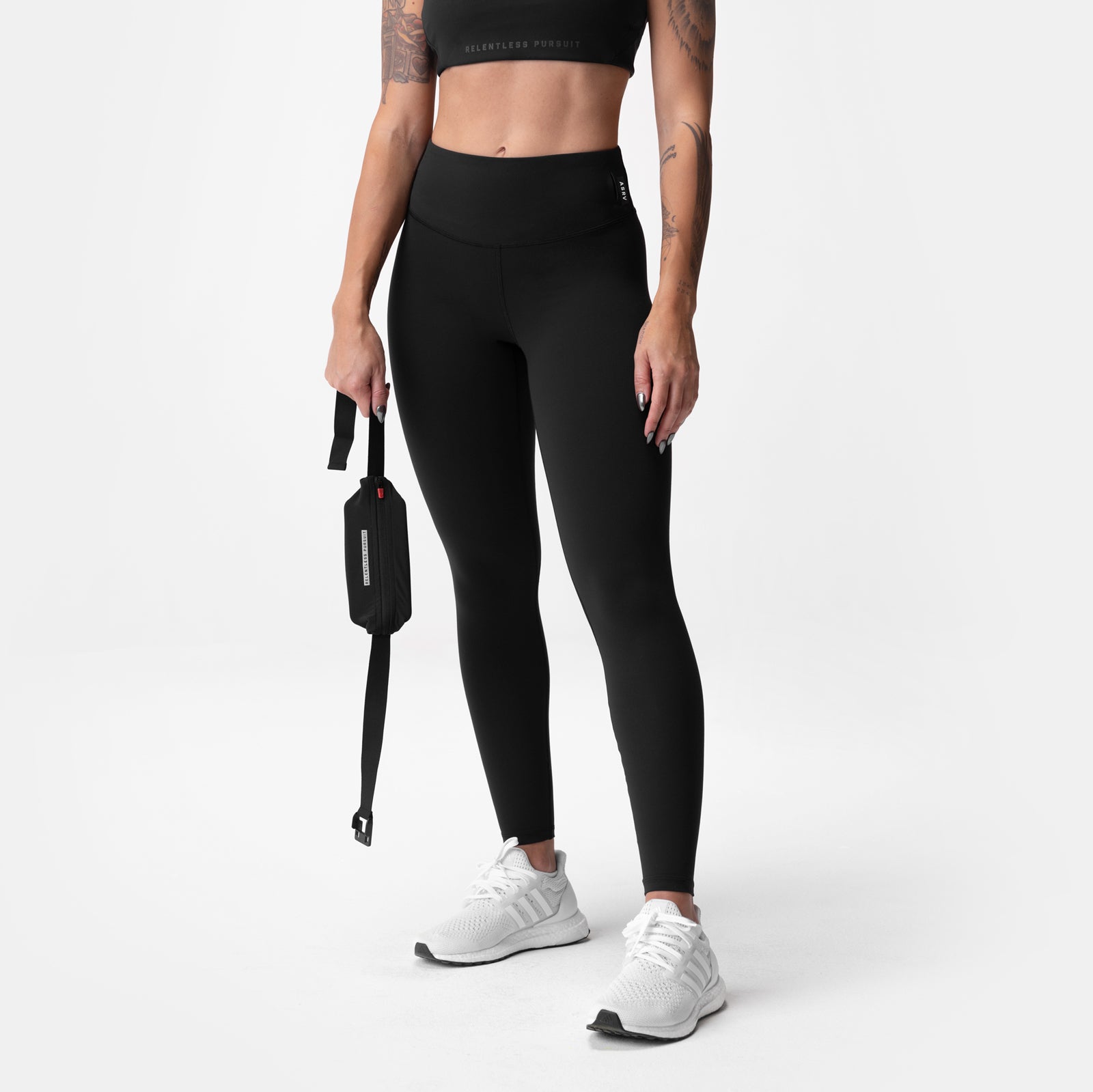 Black ASRV Lycra 3-in-1 leggings on model, front view with white sneakers
