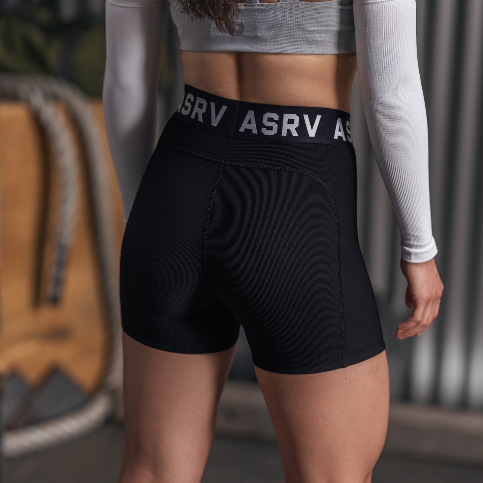 W027 Lycra Ribbed Short in black, worn by model from behind