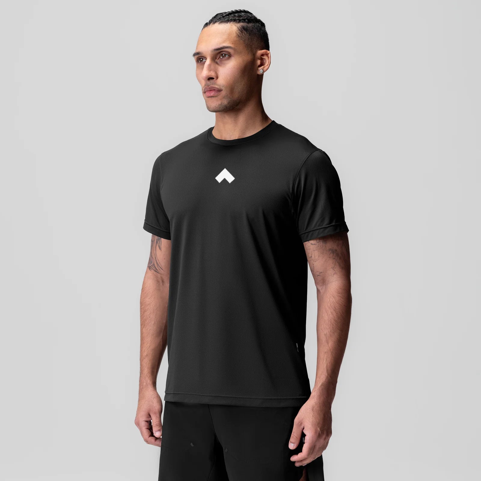 Black ASRV Essential Tee with white logo, worn by model, front view