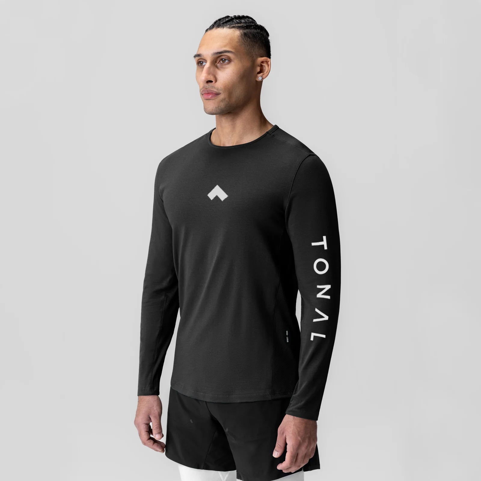 Black long sleeve shirt with TONAL branding on sleeve, worn by model, front view