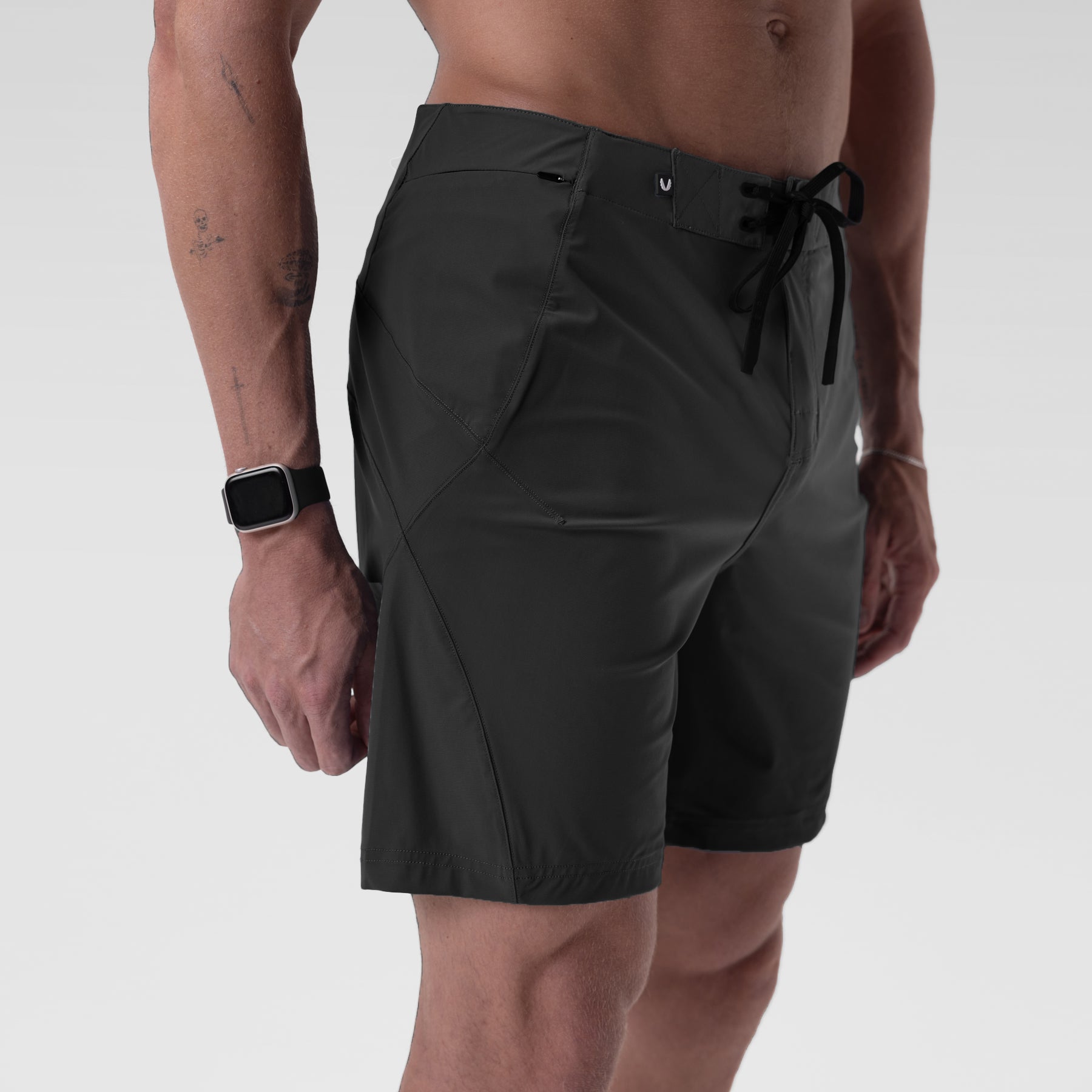 Black Revolutional® Board Short worn by model, side view