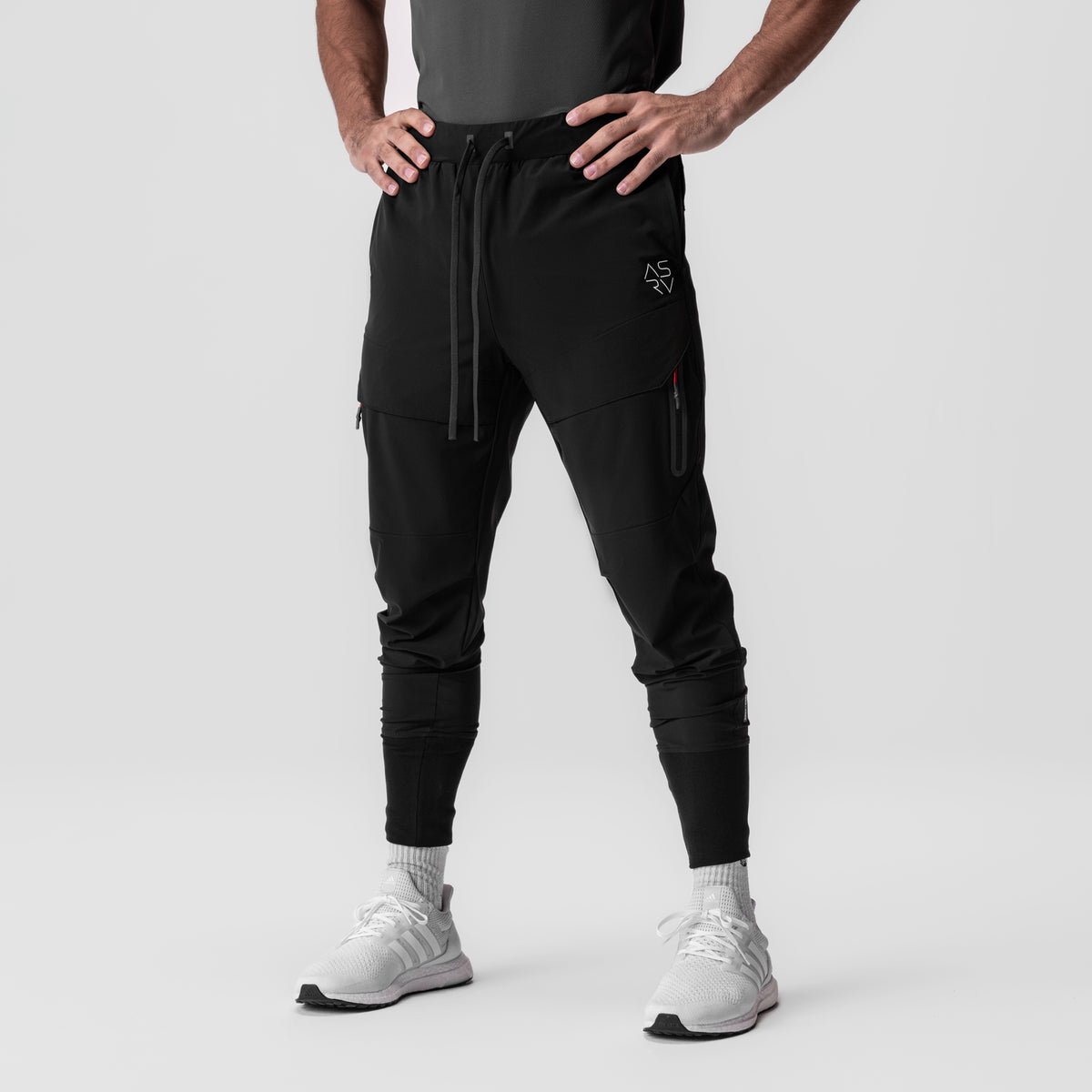 Tetra-Lite® Tech High Rib Jogger in black, modeled from waist down with white sneakers