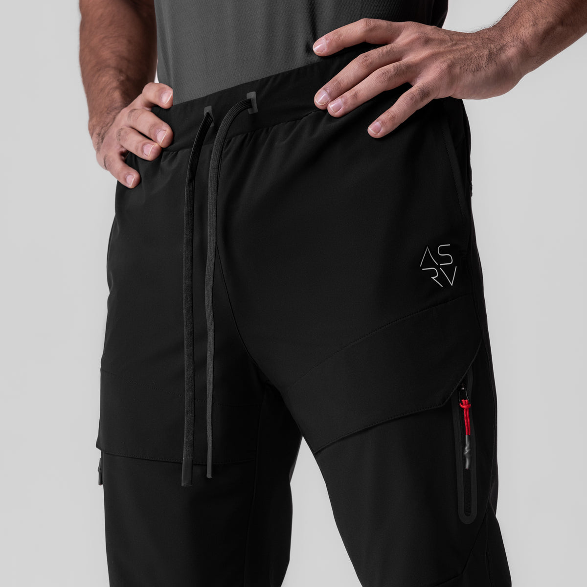 Black Tetra-Lite Tech High Rib Jogger worn by model, front view showing cargo pockets and drawstring