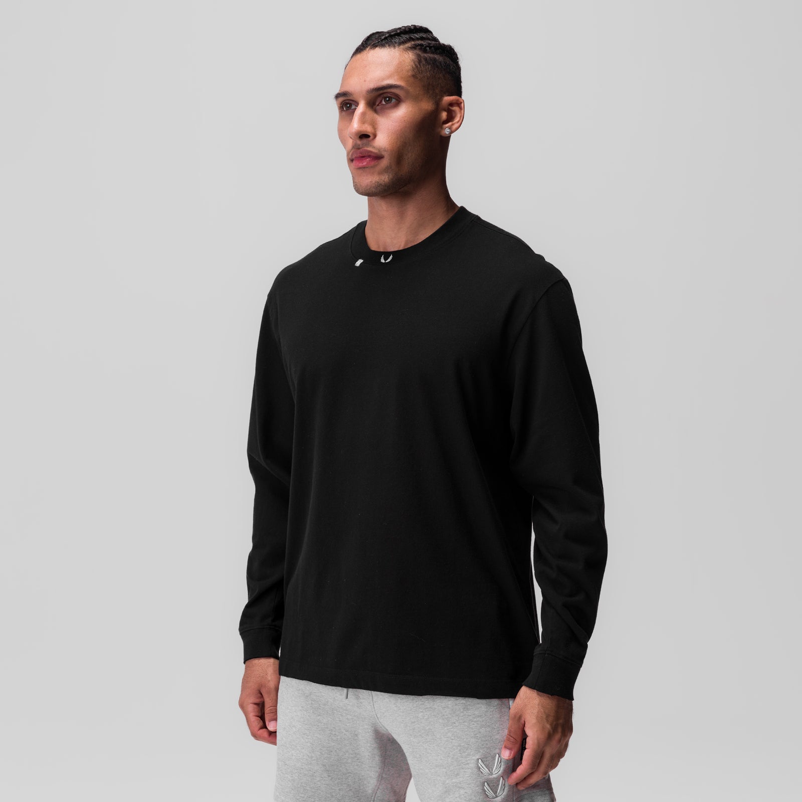 Tech Essential Relaxed Long Sleeve in black, worn by model, front view