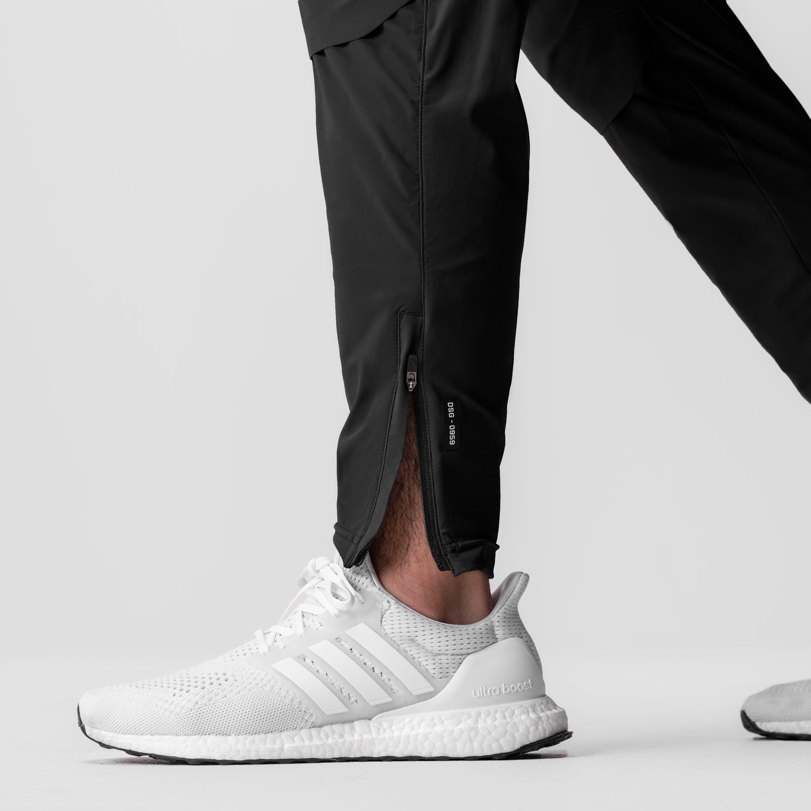 Black Tetra-Lite® Moto Jogger worn by model with white sneakers, side view
