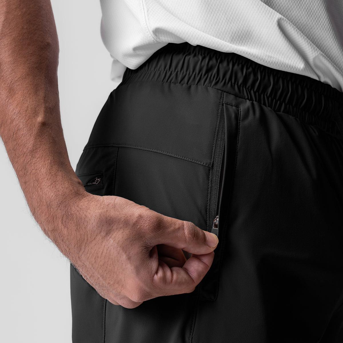 Black Tetra-Lite Moto Jogger worn by model, side pocket detail view