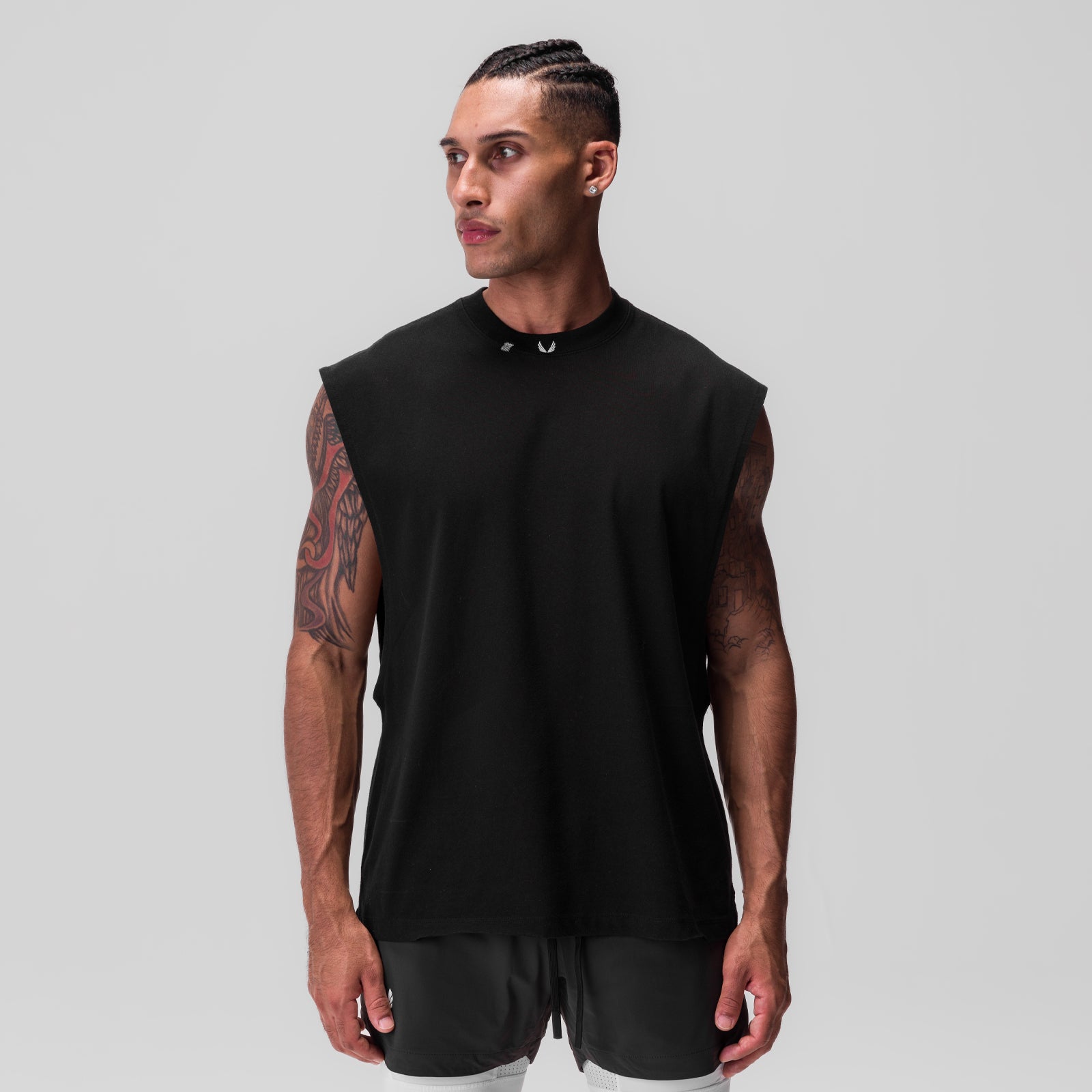 Black Tech Essential Rocker Cutoff sleeveless tank on model, front view